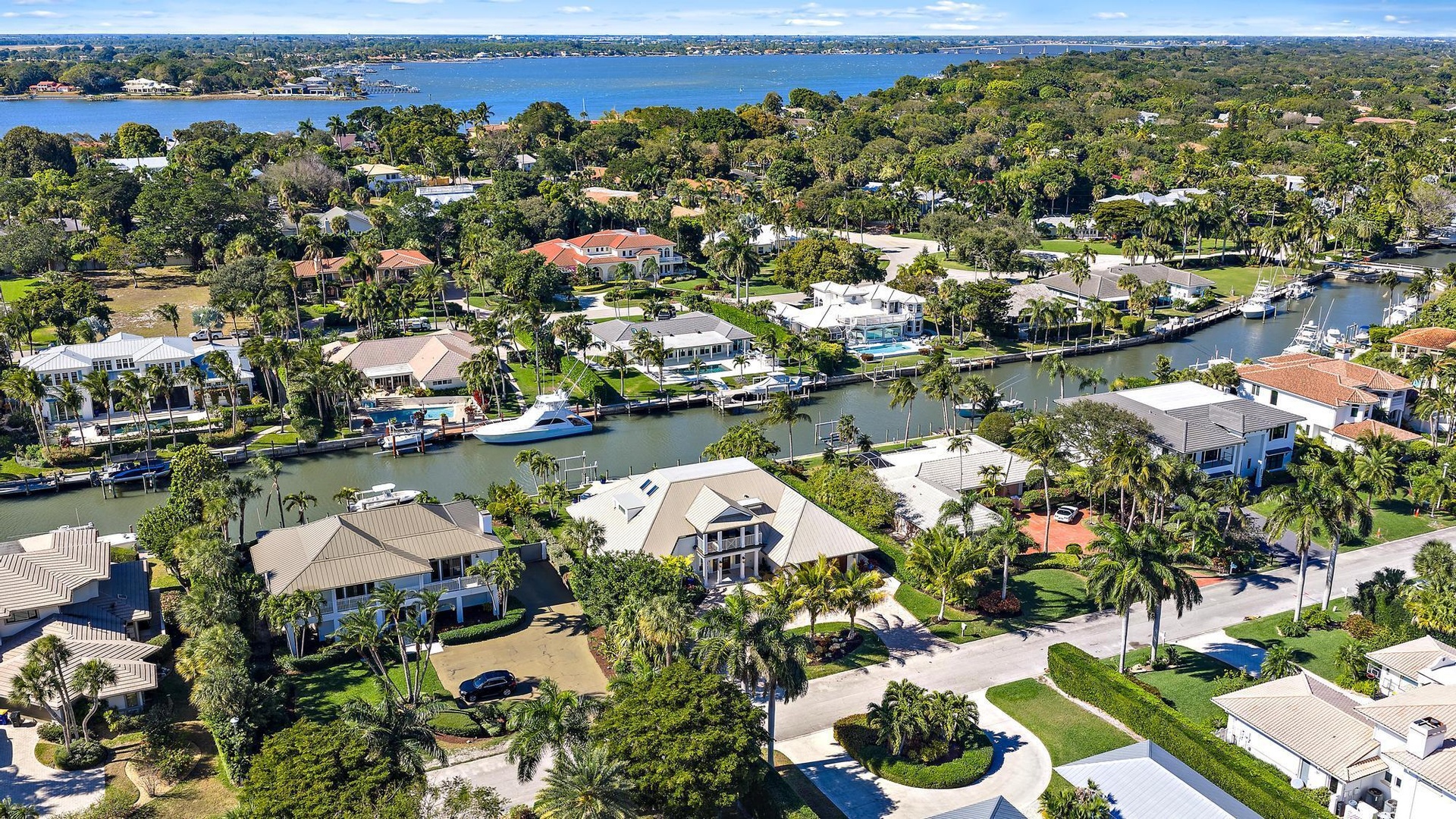 Aerial perspective of waterfront properties featuring deep-water canal access, private boat docks, and established coastal vegetation