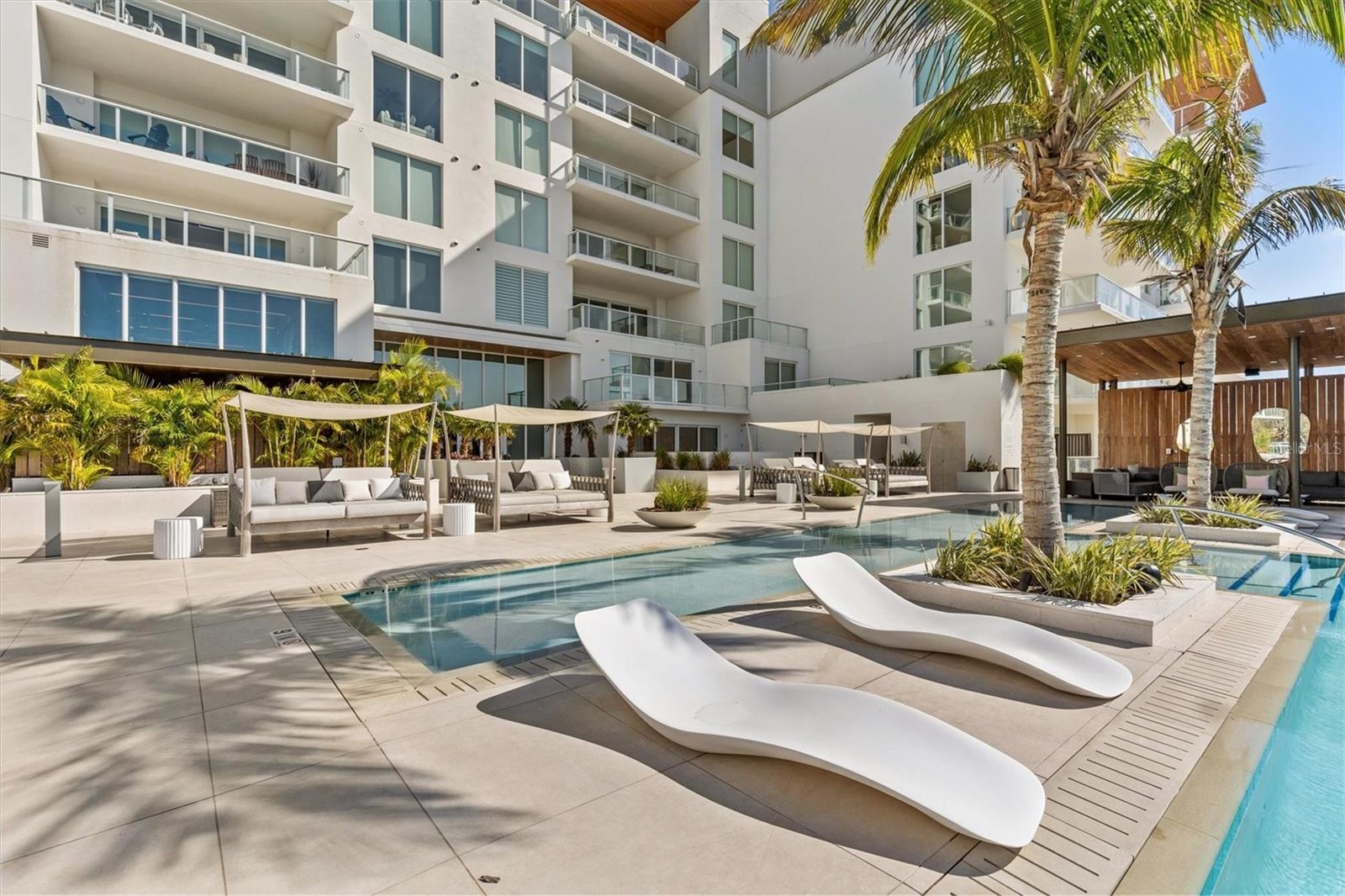 pool lounging area with cabanas