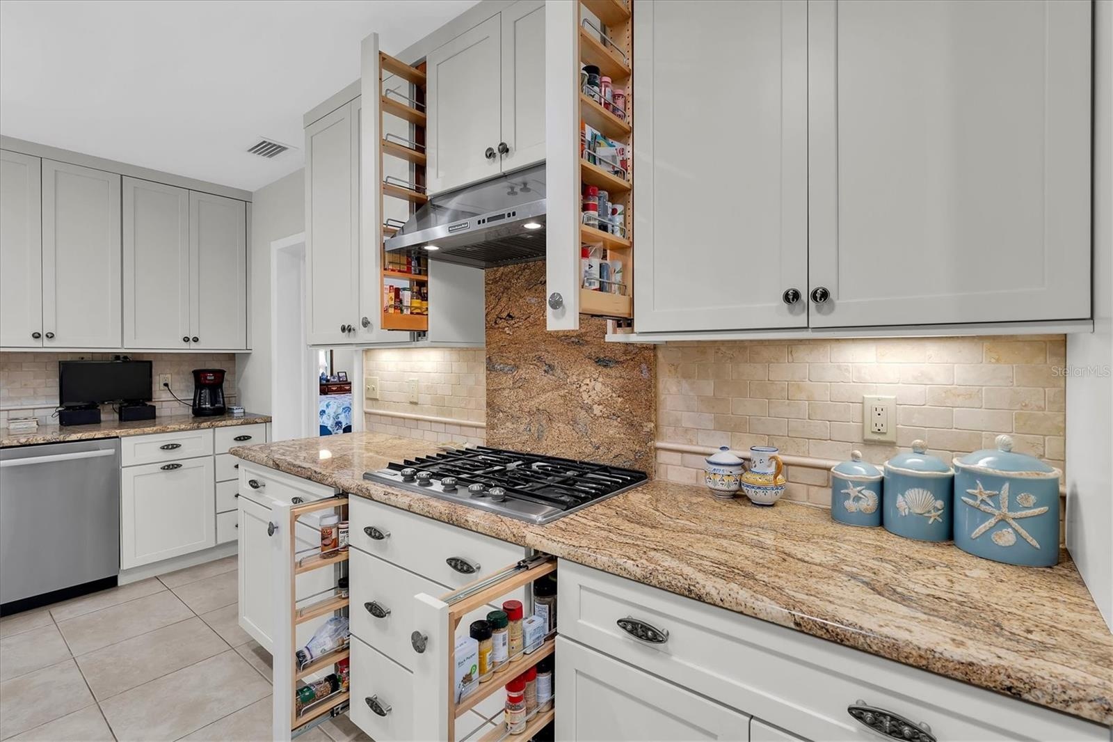 Kitchen Aid 5 burner gas stove with 4 pull out spice racks for the cook.