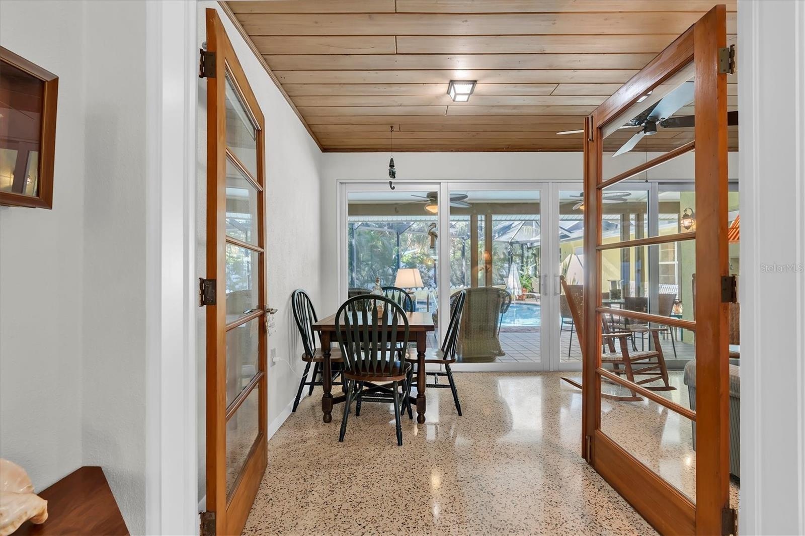 French doors open to Florida room provides extra dining and seating space overlooking the pool and spa.