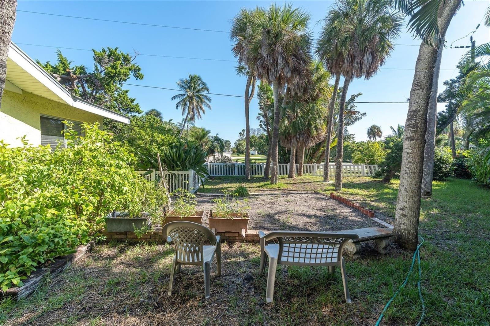 Large side yard with garden space, room for the kids and dogs to play or a game of cornhole. Lot size is 9,424 square feet if you want to renovate or 