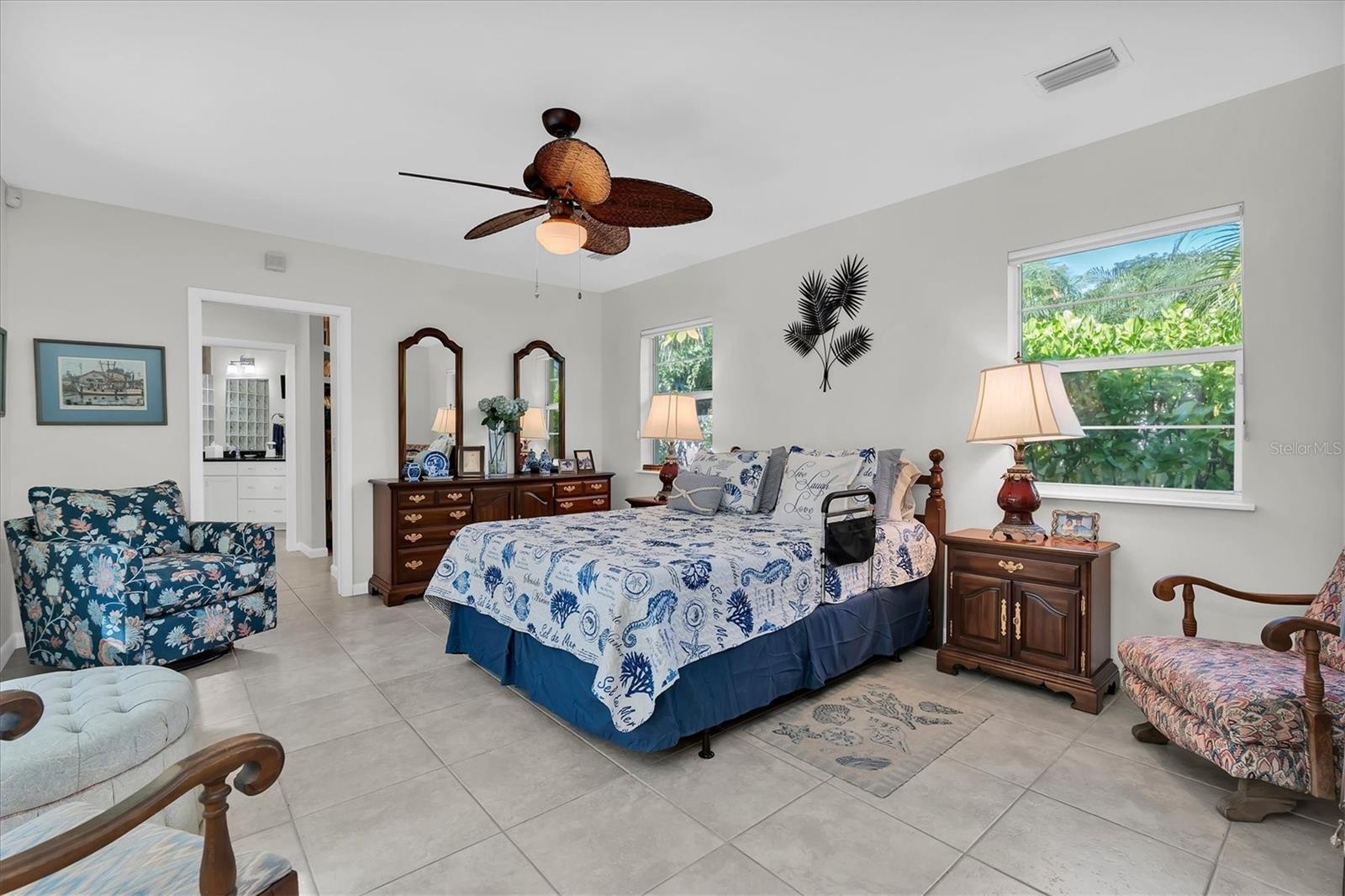 Private primary bedroom with large walk-in closet and en-suite bath has a lot of space to sit and relax.