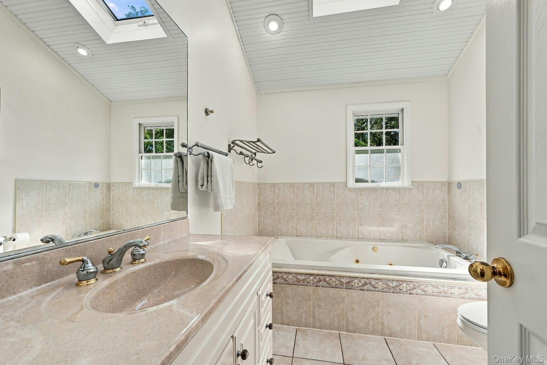 Spacious bathroom with separate shower and whirlpool tub.