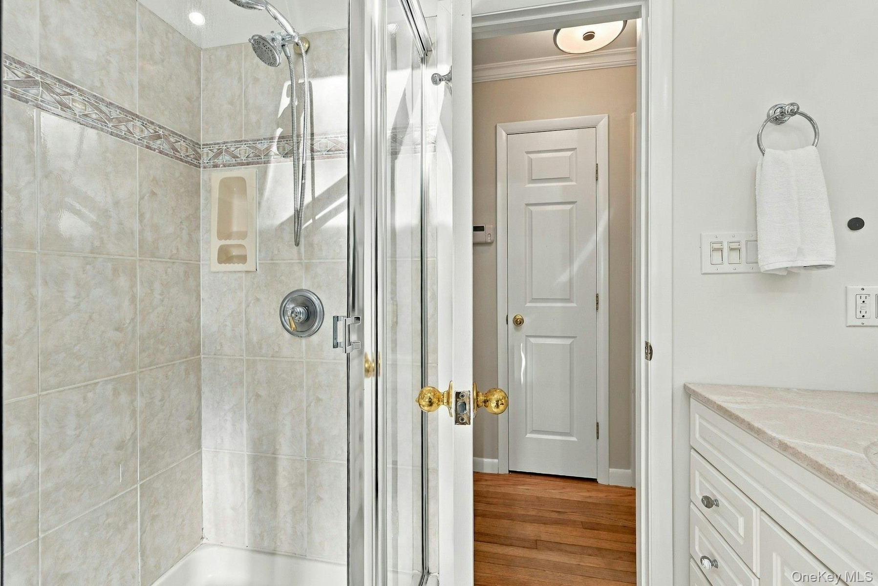 Separate shower with ceramic tiling.