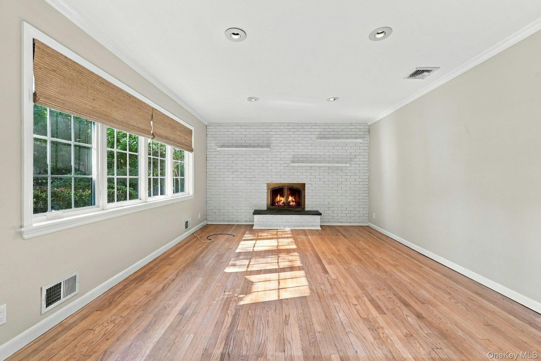 Brick accent wall with open shelves.