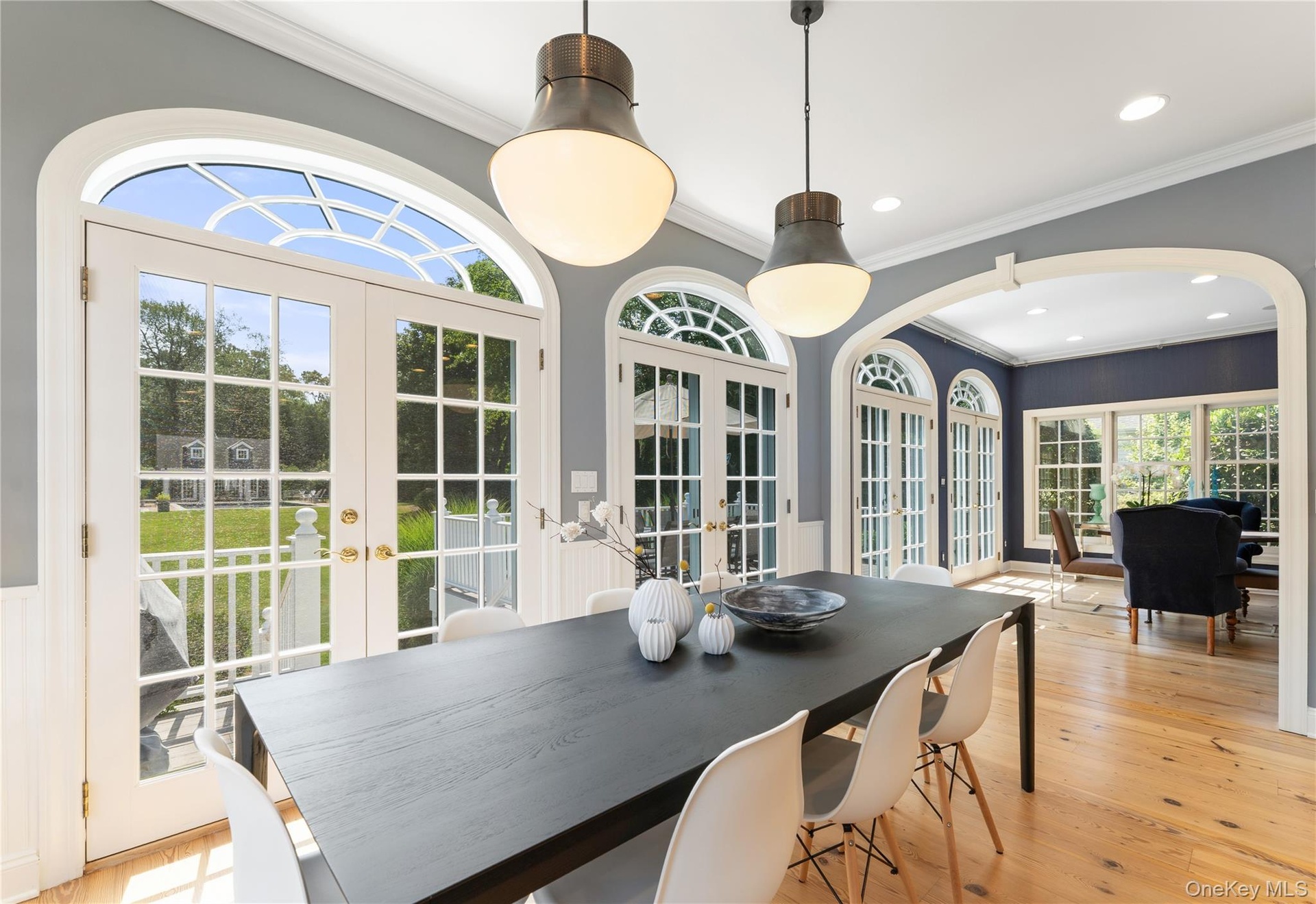 A wall of French doors continue from the breakfast room to the family room and lead you to a deck overlooking the expansive property