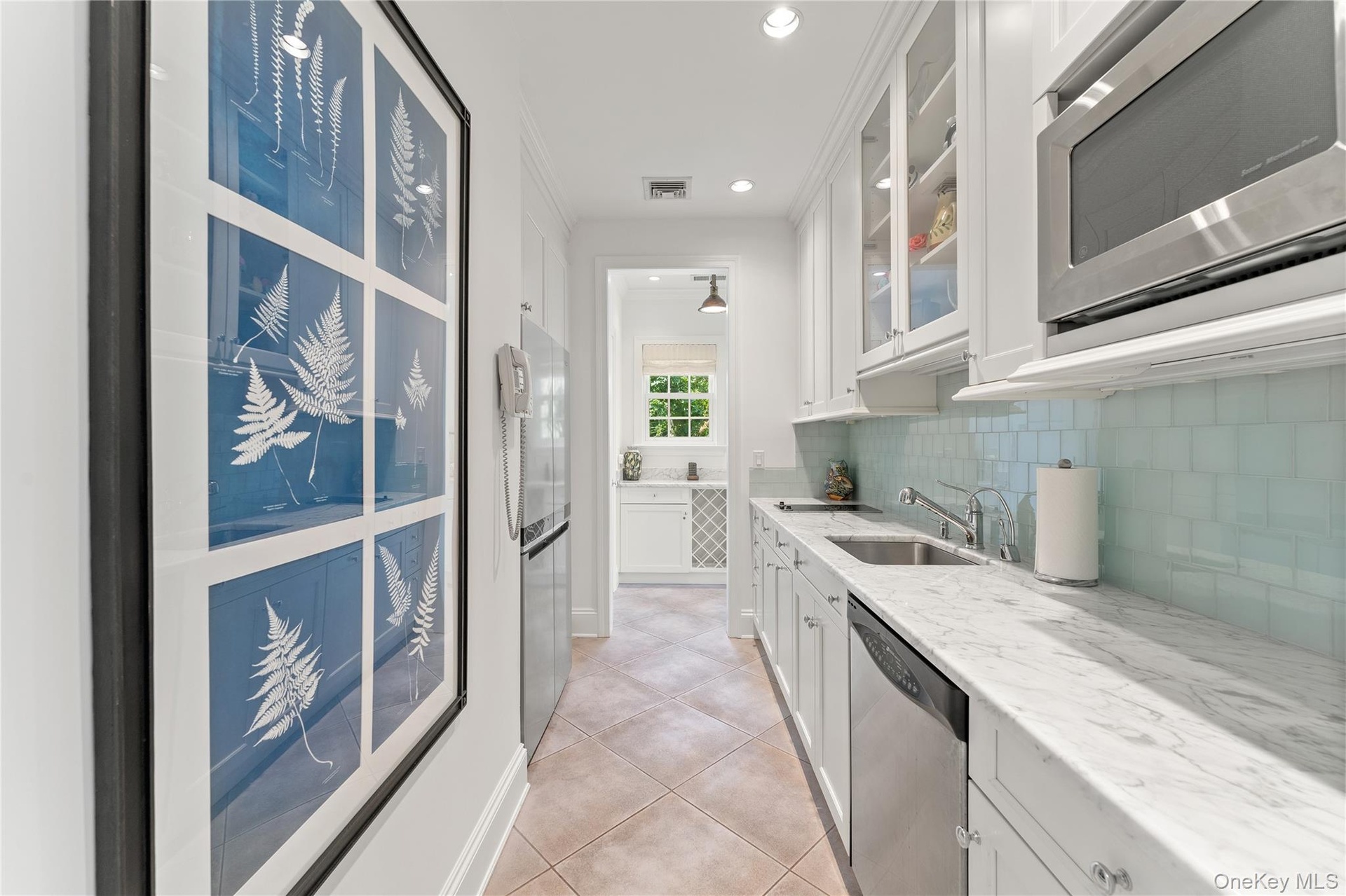 Full kitchen, electric stove top, dishwasher, refrigerator, marble counter tops, glass backsplash
