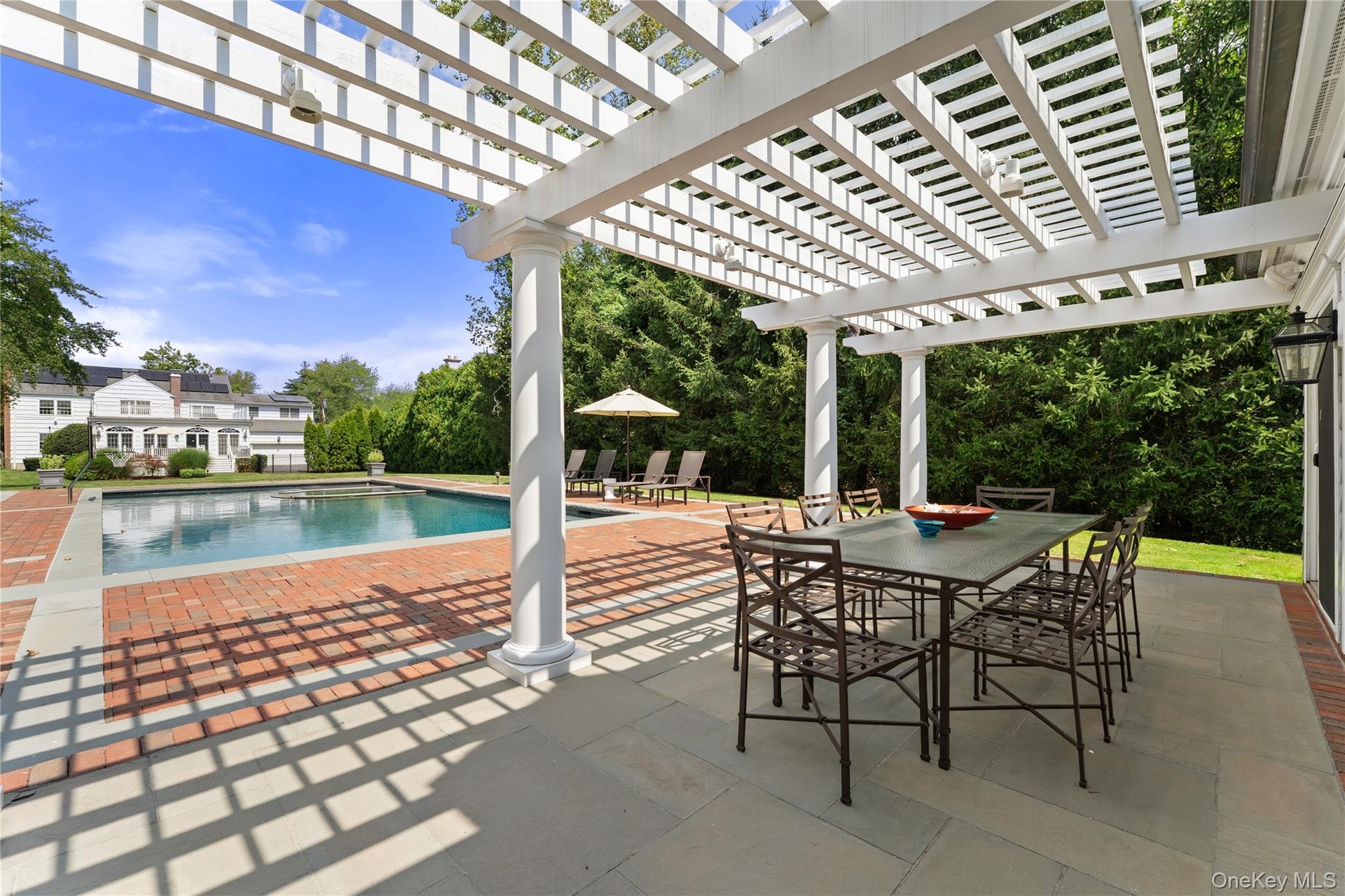 Fabulous pergola and bluestone patio outside of pool house
