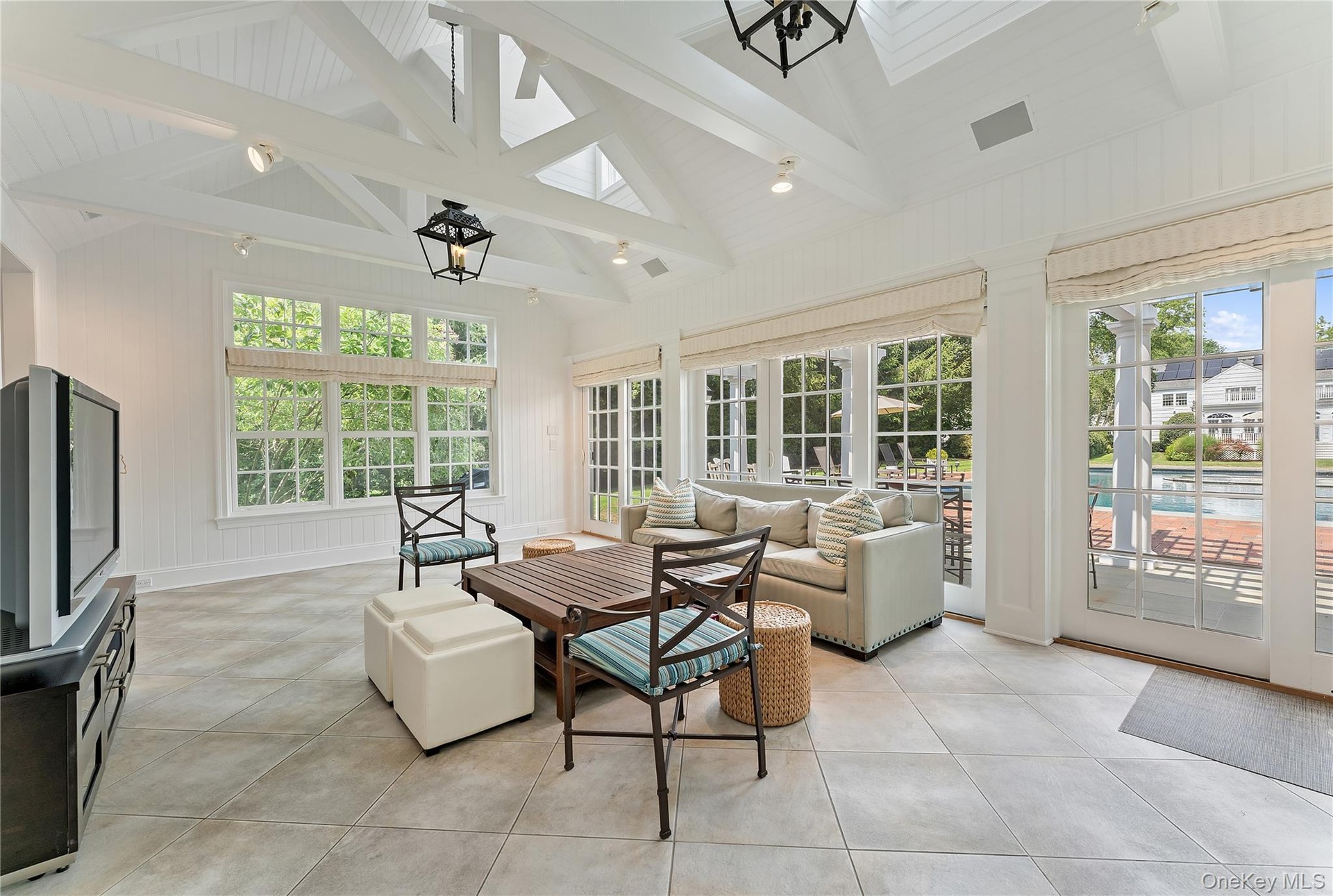 Sun drenched Pool house. Spectacular living room with  high beamed ceiling