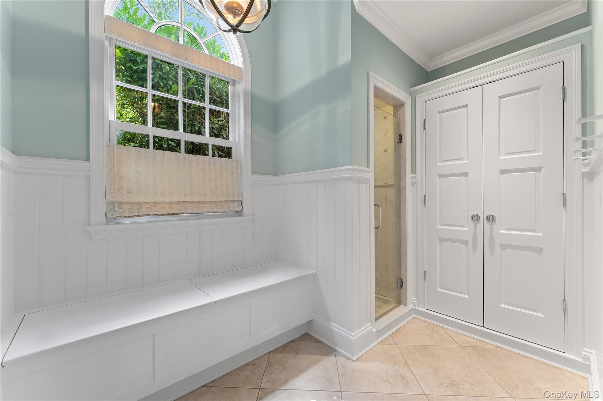 Guest changing area with stand alone shower, linen closet