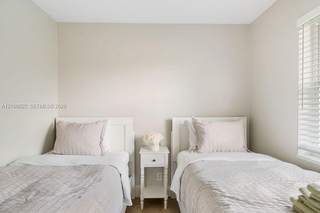 Neutral wall palette, wood-finish flooring, and horizontal window blinds