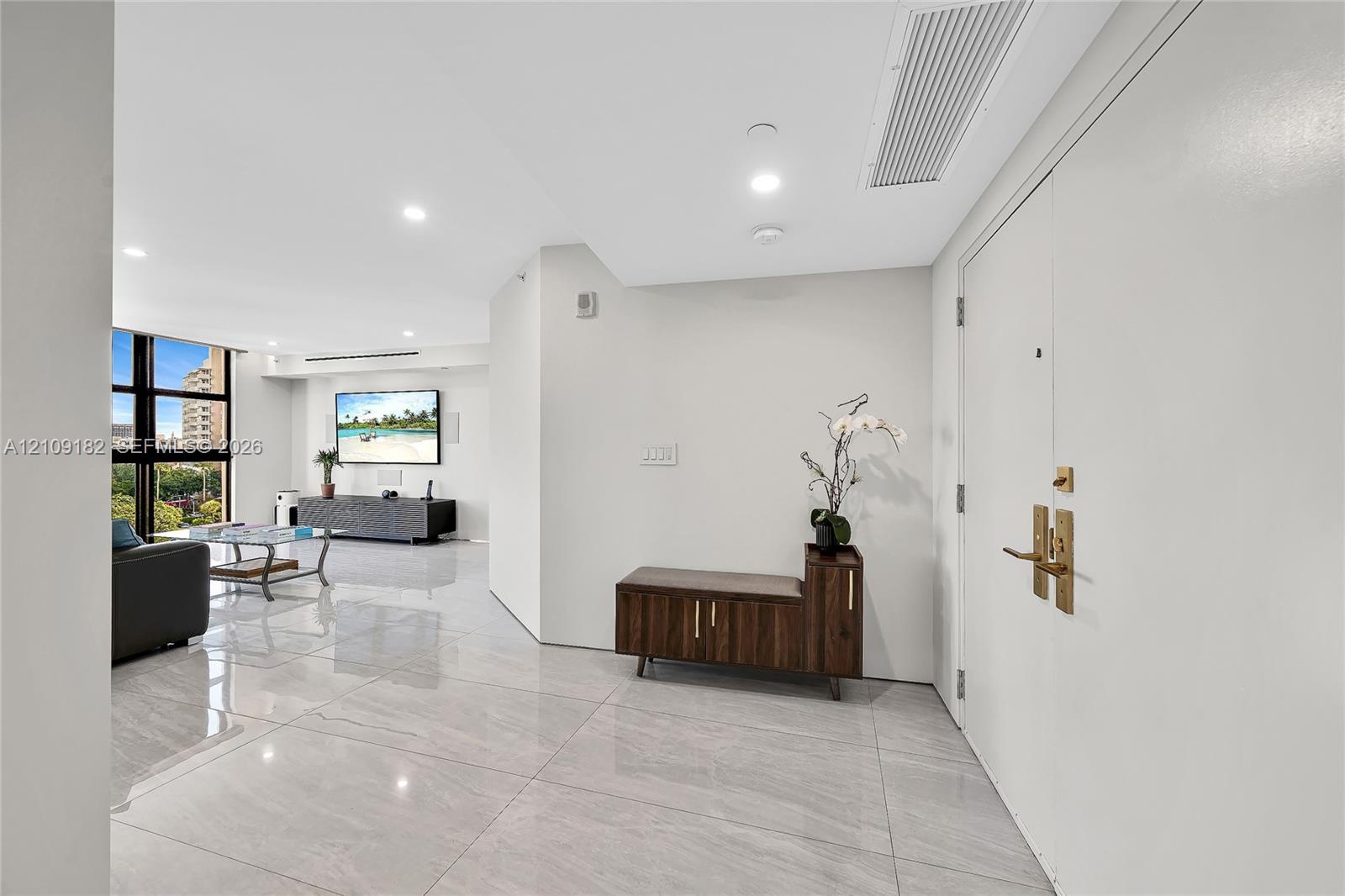 Polished stone-finish flooring, floor-to-ceiling windows, and recessed lighting
