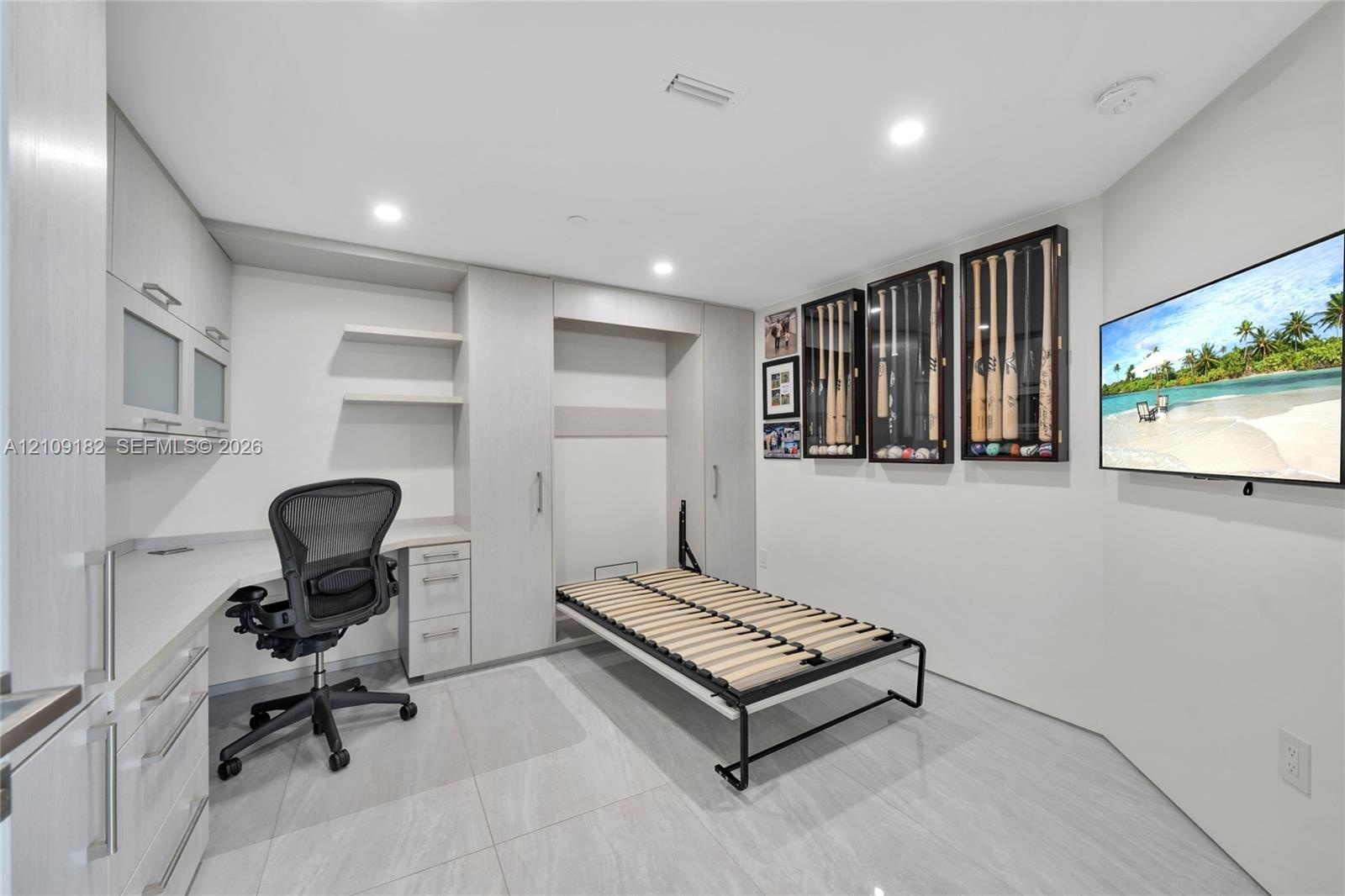 Contemporary kitchen featuring flat-panel cabinetry, a spacious island with a solid-surface countertop, integrated wine refrigeration, and large-forma