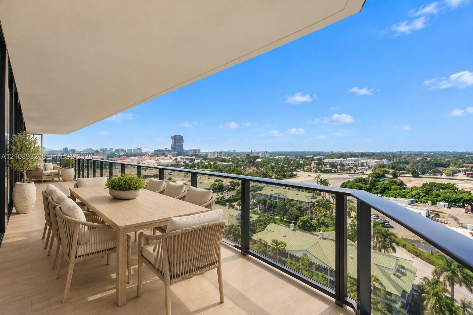 Covered balcony featuring wood-finish flooring and a black metal railing