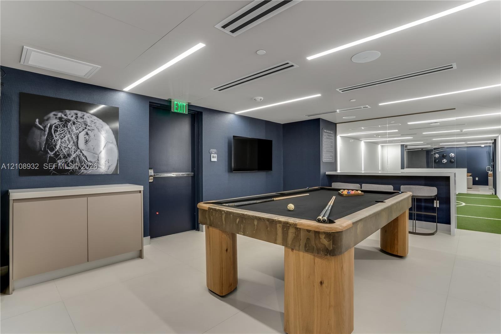 Large-format tile flooring, recessed linear LED lighting, and built-in minimalist cabinetry