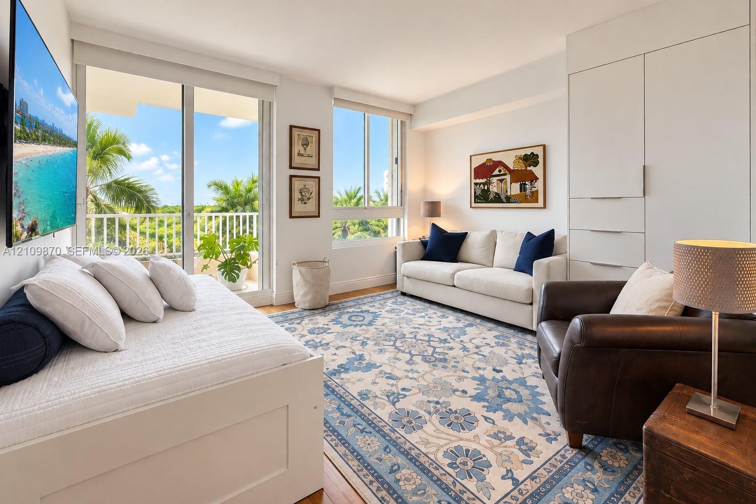 Living area featuring floor-to-ceiling windows, sliding glass door access to an exterior balcony, built-in floor-to-ceiling cabinetry, and light-toned