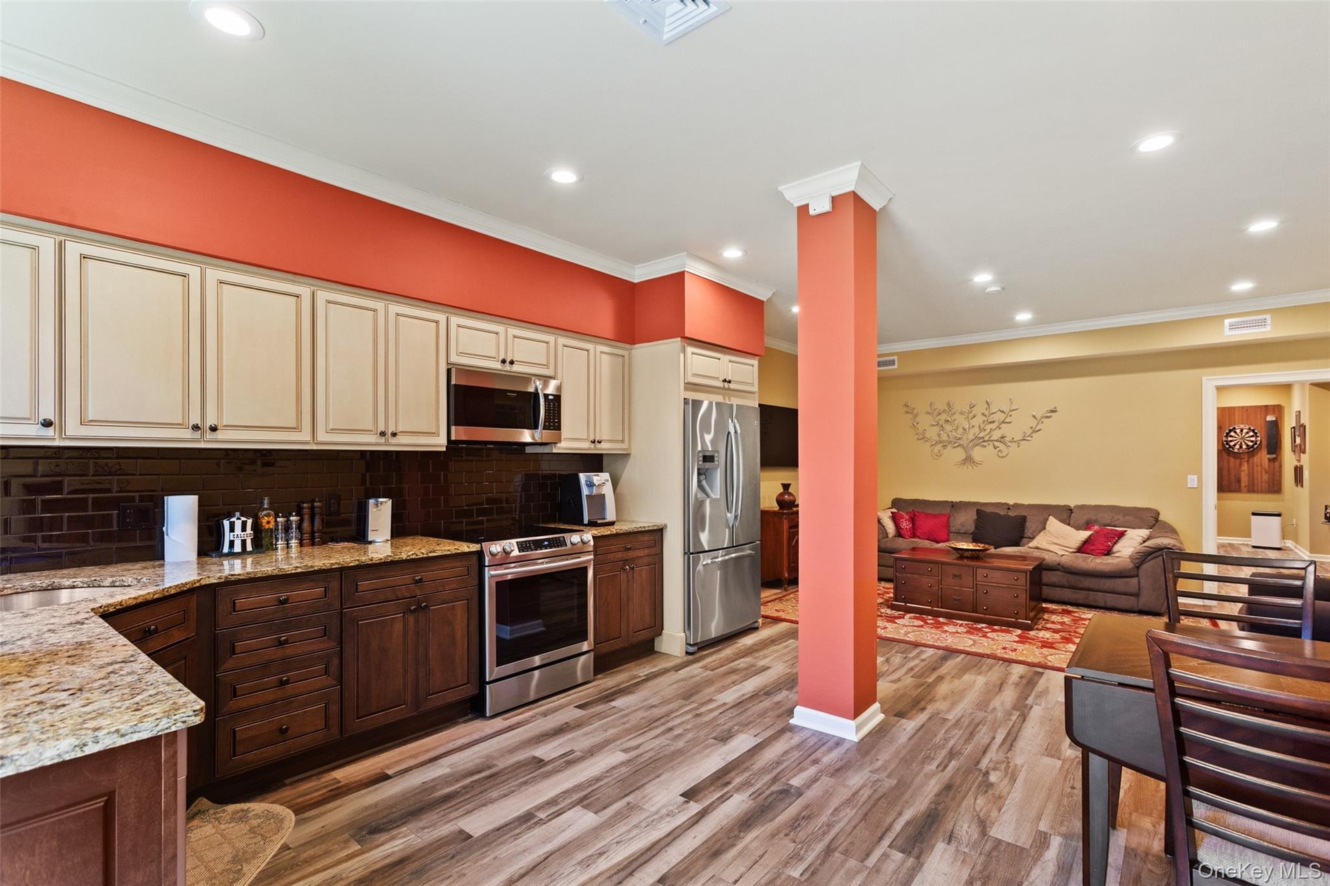 LEGAL ACCESSORY APARTMENT featuring Kitchen with appliances with stainless steel finishes, cream cabinets, open floor plan, tasteful backsplash, and l