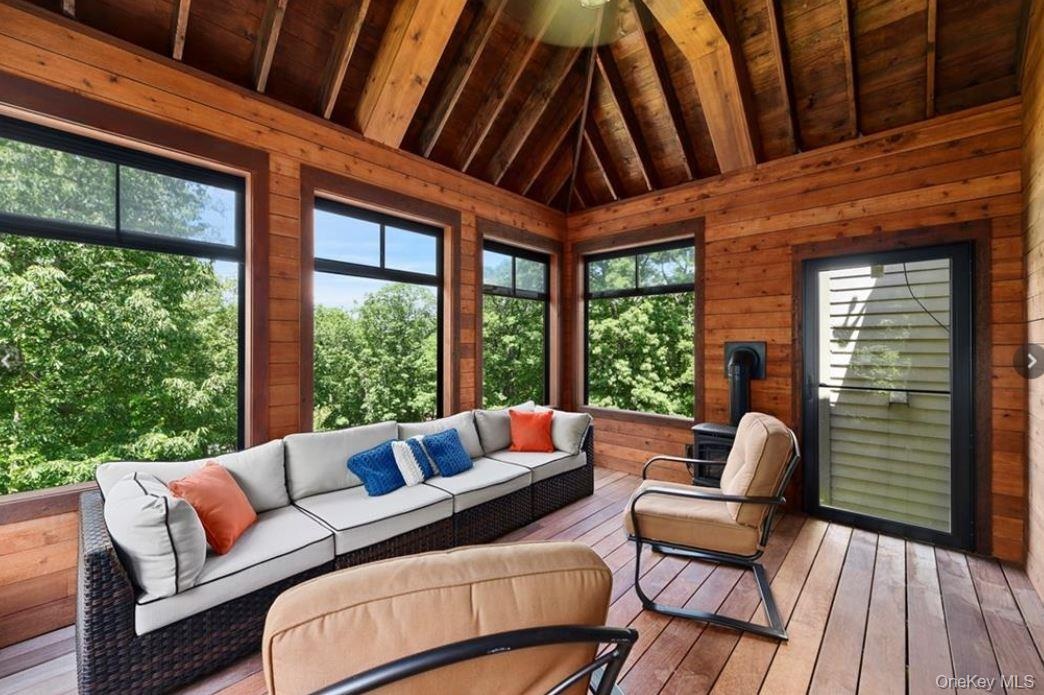 Sunroom with outdoor lounge area and lofted ceiling