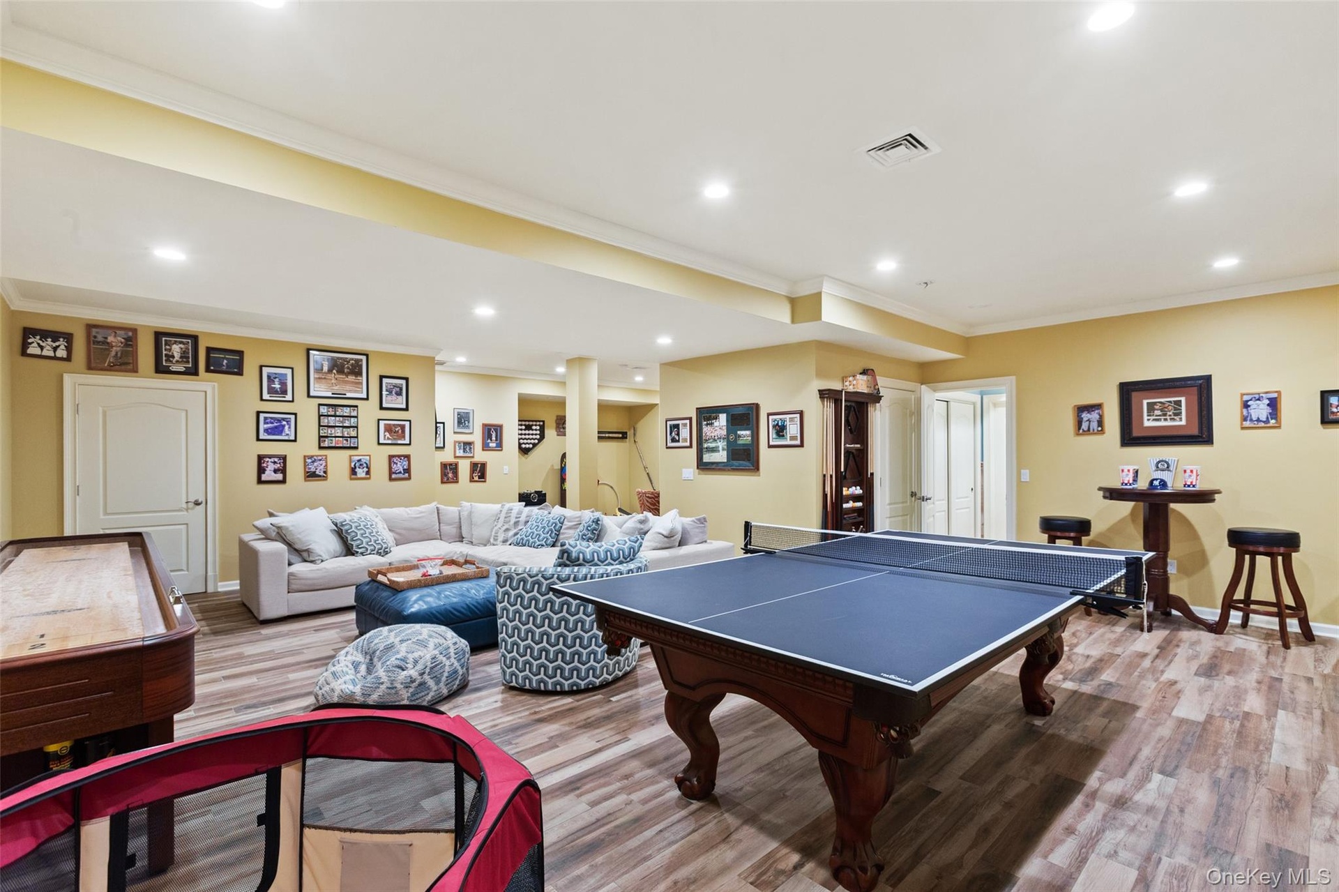 Game room with recessed lighting, wood finished floors, ornamental molding, and baseboards