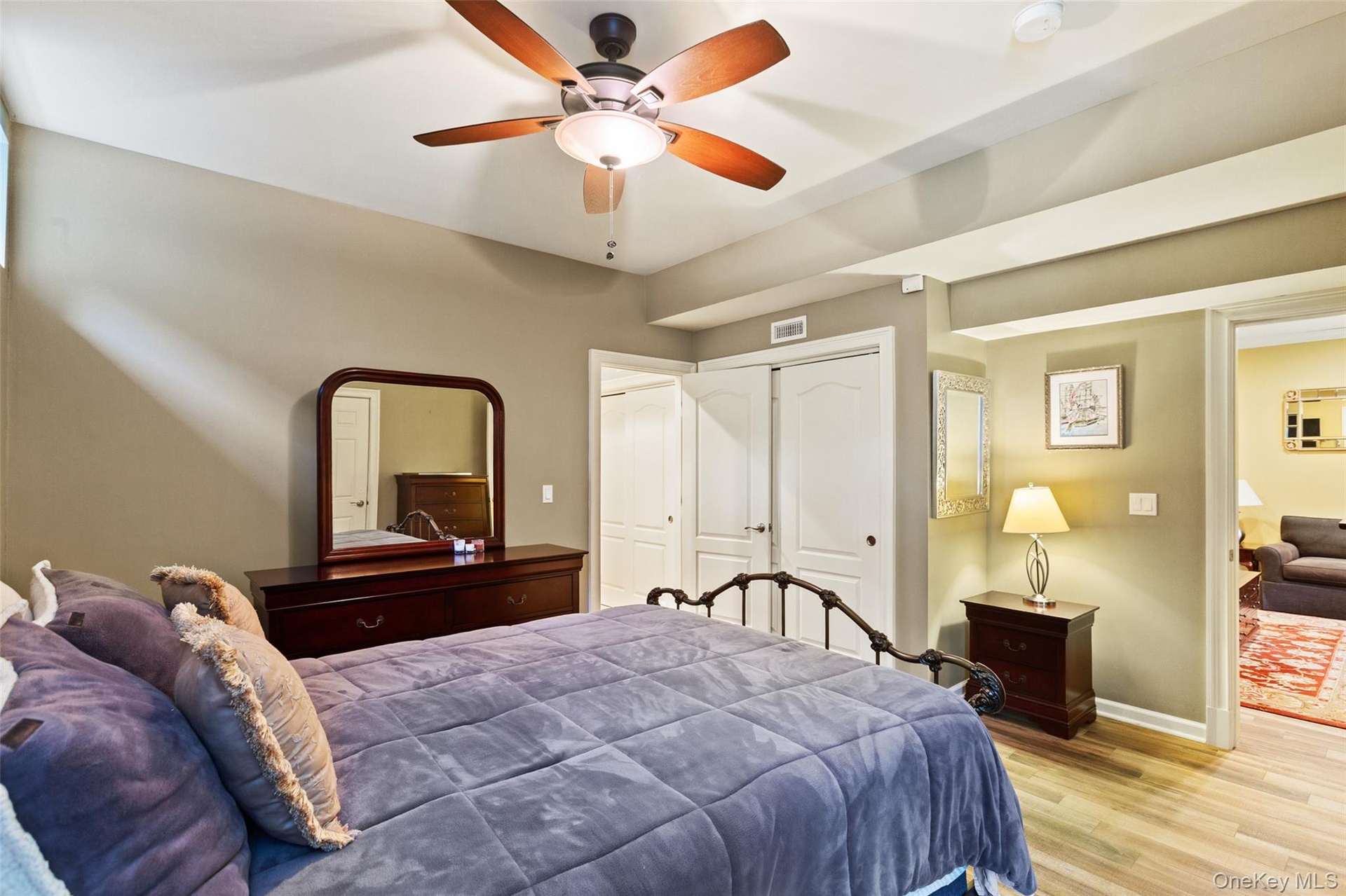 Bedroom featuring light wood-style flooring, baseboards, a closet, and ceiling fan
