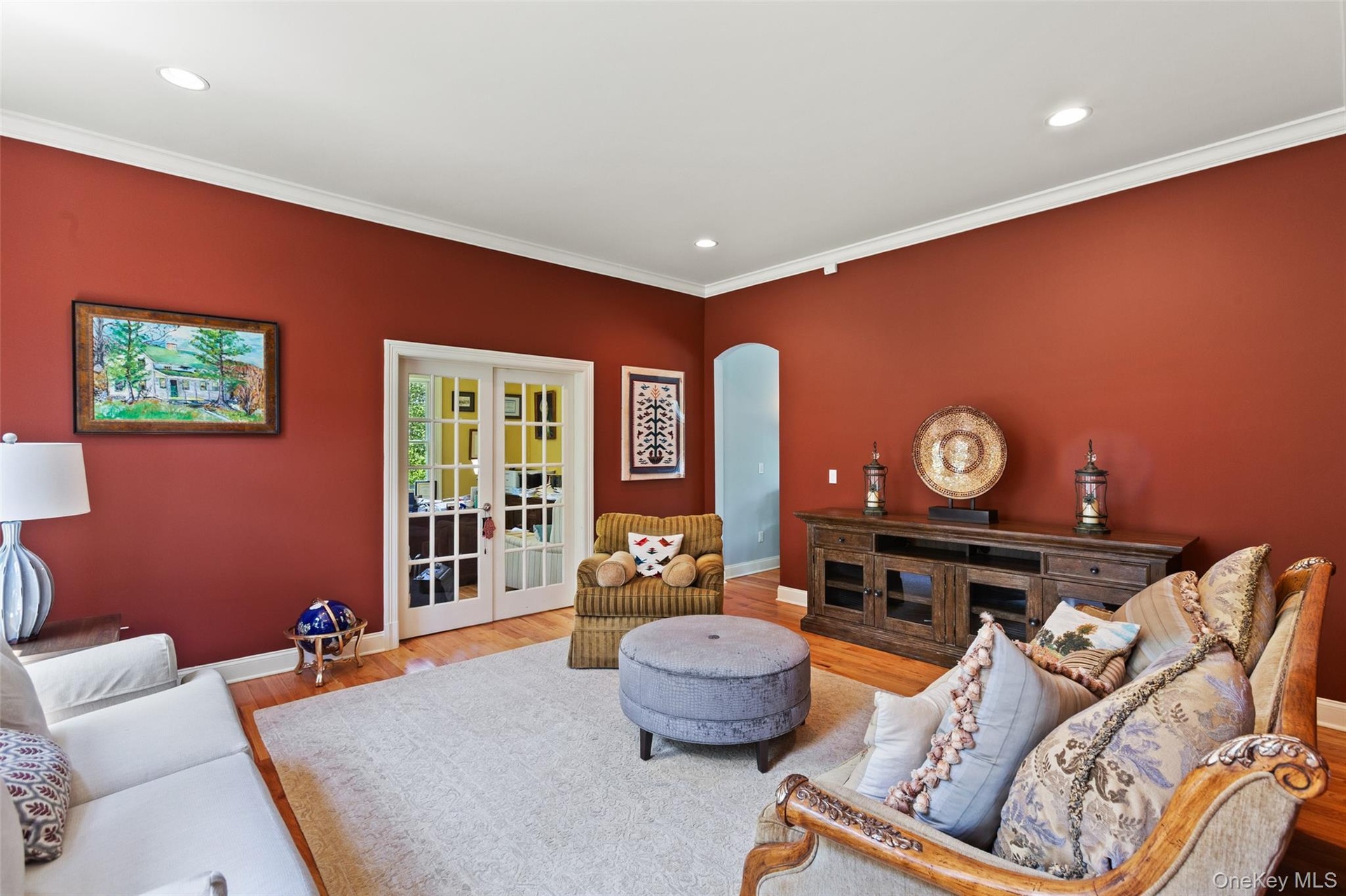 Living area with baseboards, wood finished floors, crown molding, french doors, and recessed lighting
