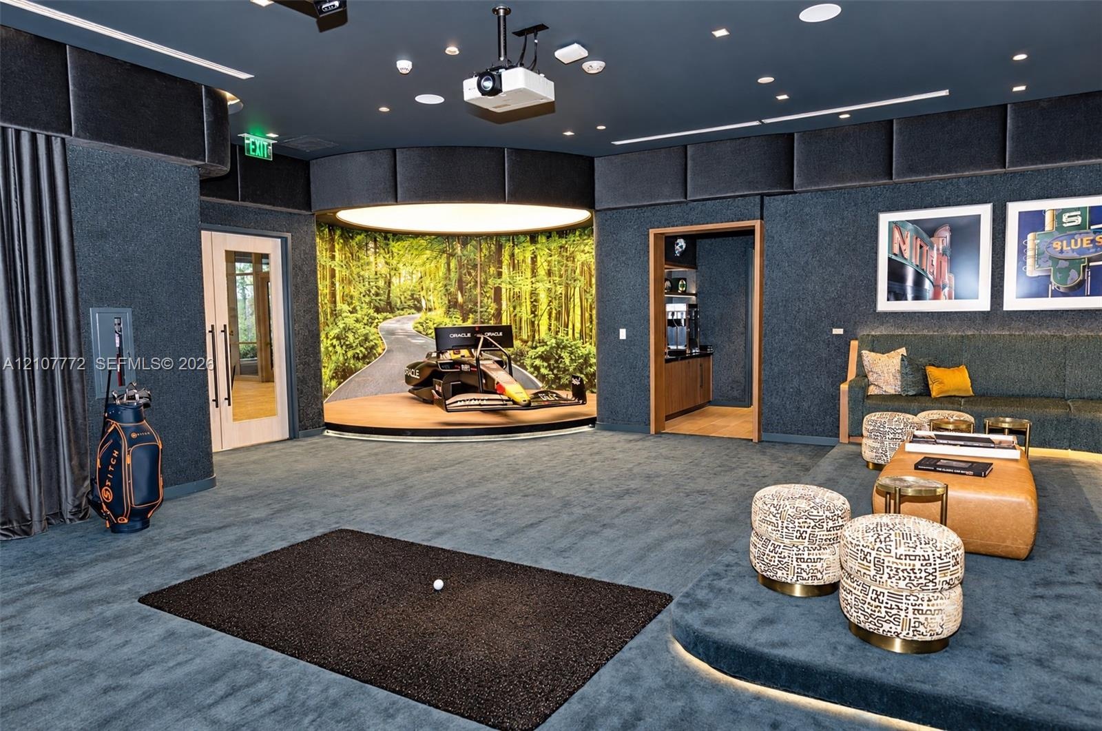 Custom media room featuring acoustical wall paneling, a recessed circular stage with integrated lighting, overhead projection system, elevated platfor
