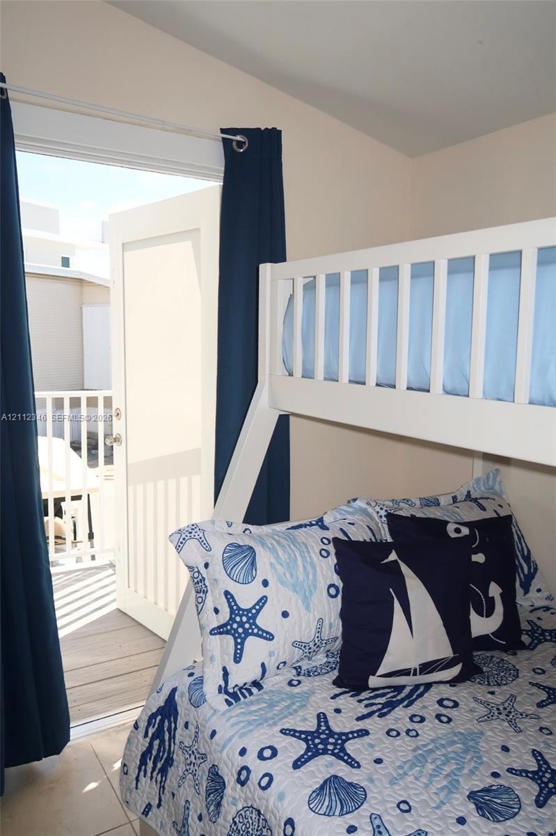 Exterior door providing access to a balcony with white metal railings