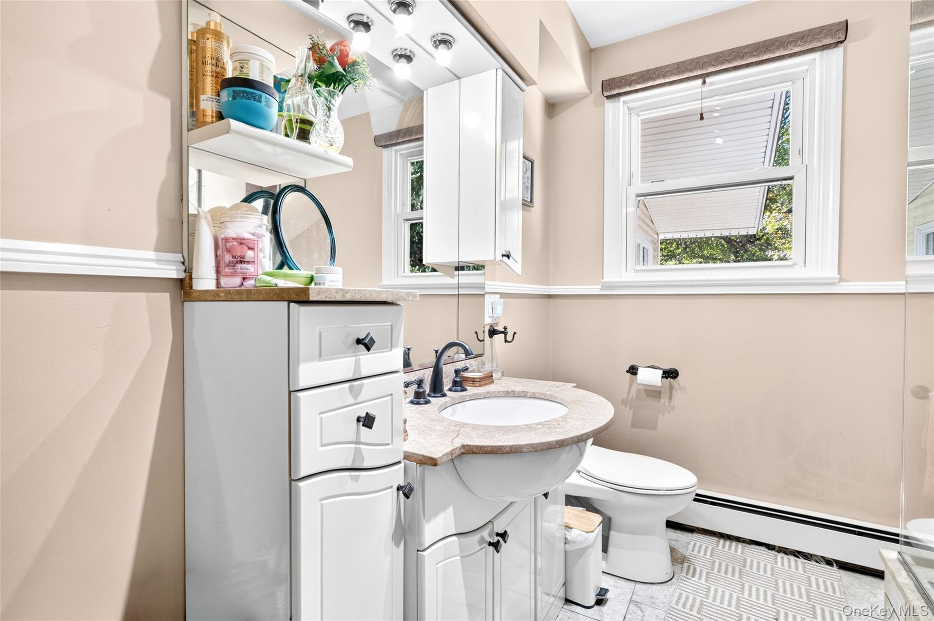 Large Bathroom on the 1st Floor, featuring vanity with extra drawers, shower stall with beautiful ceramic tiling and  window.