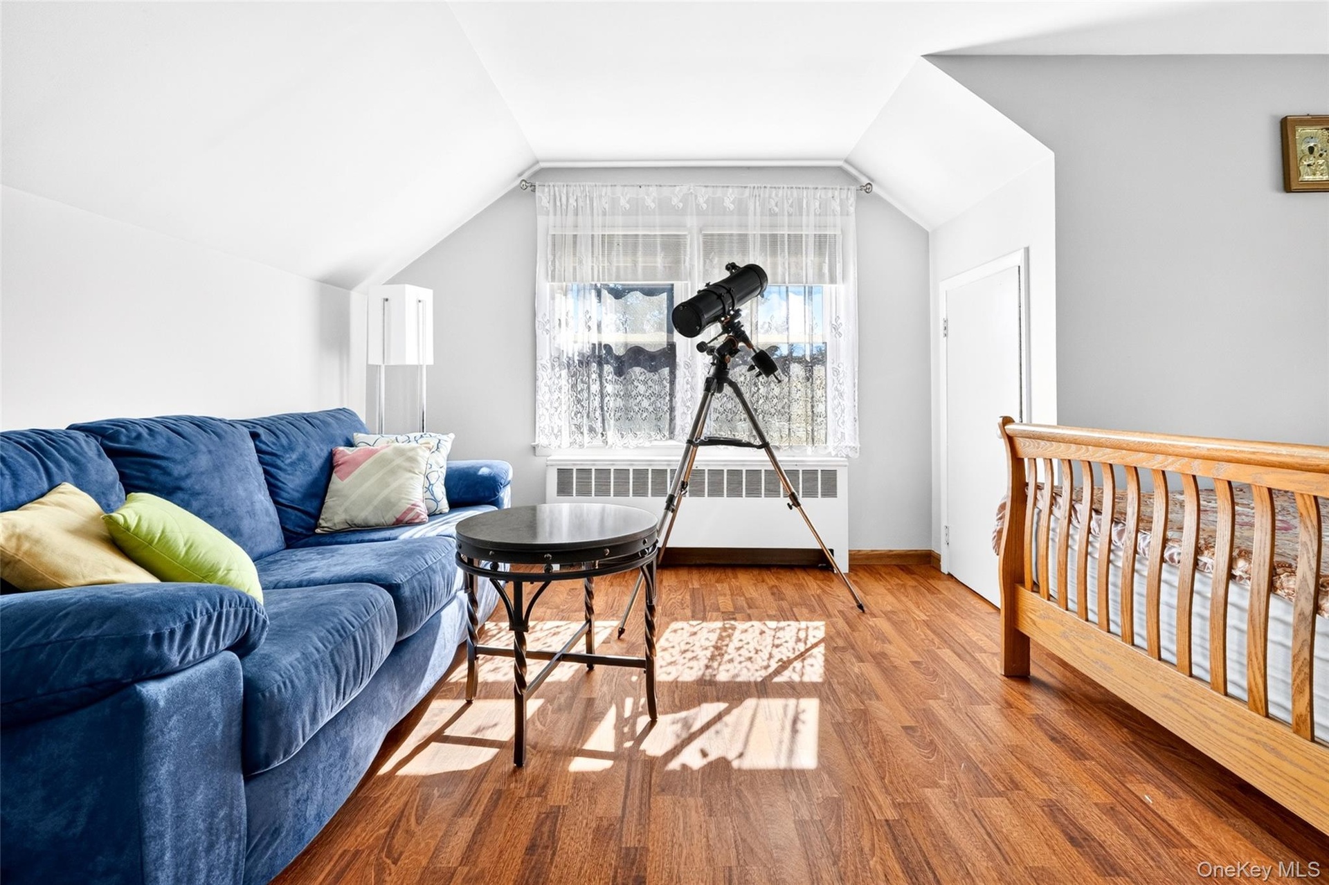 Another view of the huge and bright 4th Bedroom, featuring hardwood flooring, very large windows and 2 closets.