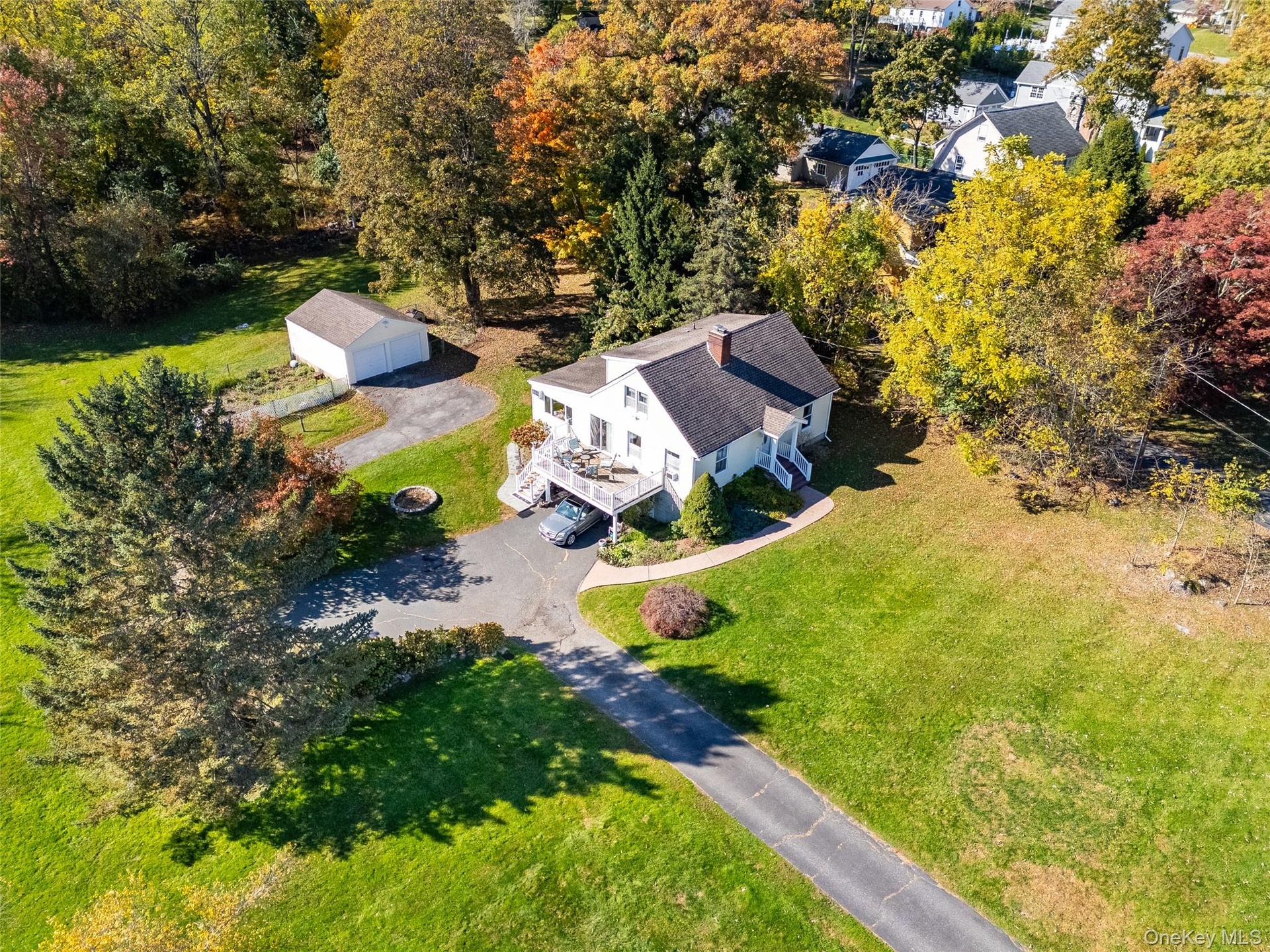 Another view of this wonderful 4 Bedroom, 2 Full bath 2,000 sq. ft Expanded Cape Cod Home. Note the huge deck/carport and the detached 2 car garage.