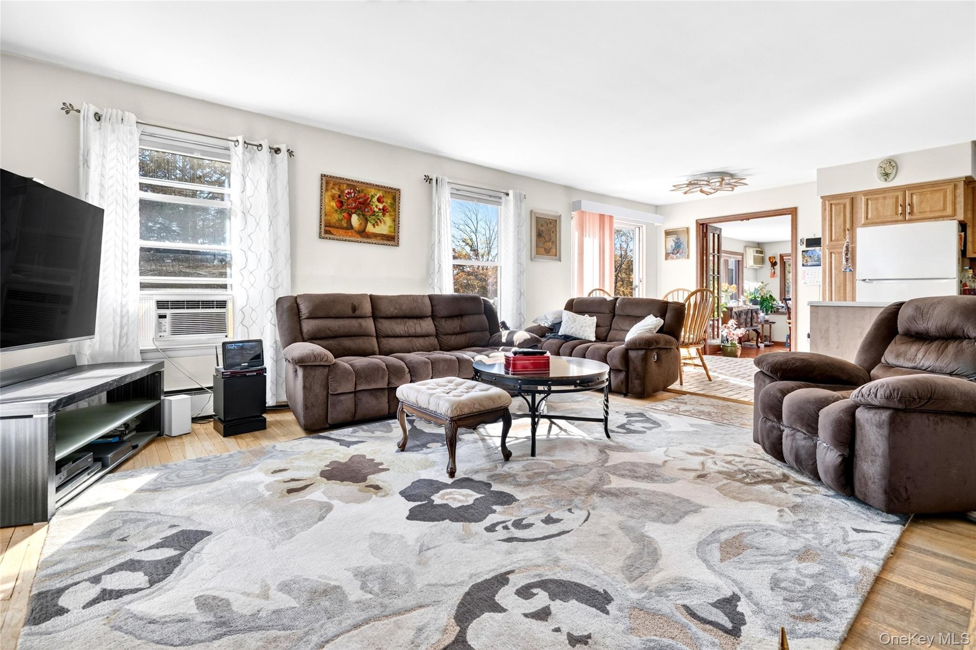 You'll be amazed when you step into this cavernous and Sunlit Living Room, featuring lots of Andersen Windows, hardwood flooring, and a warm brick Fir