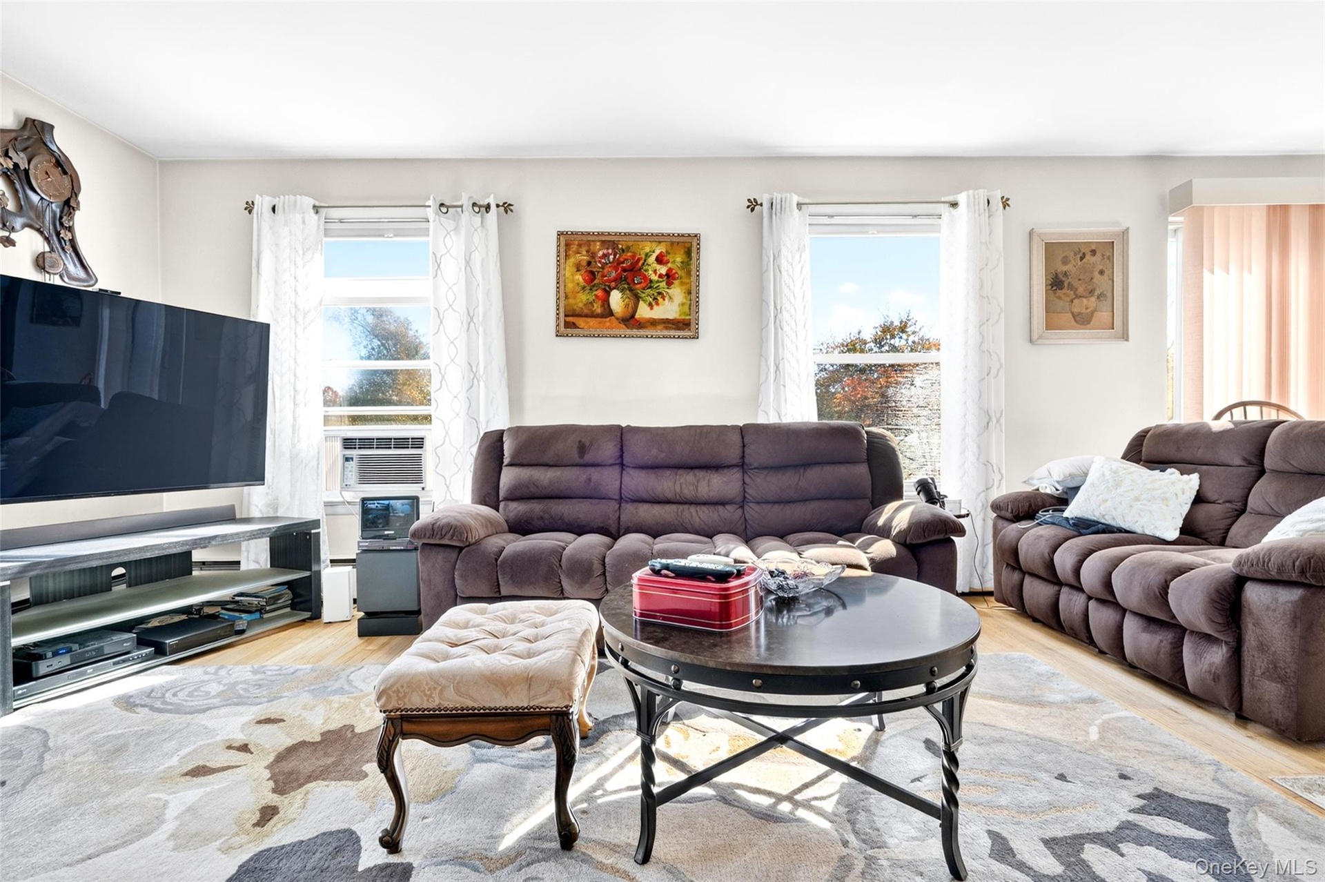Another view of the very bright, oversized, warm and inviting Living Room with hardwood flooring