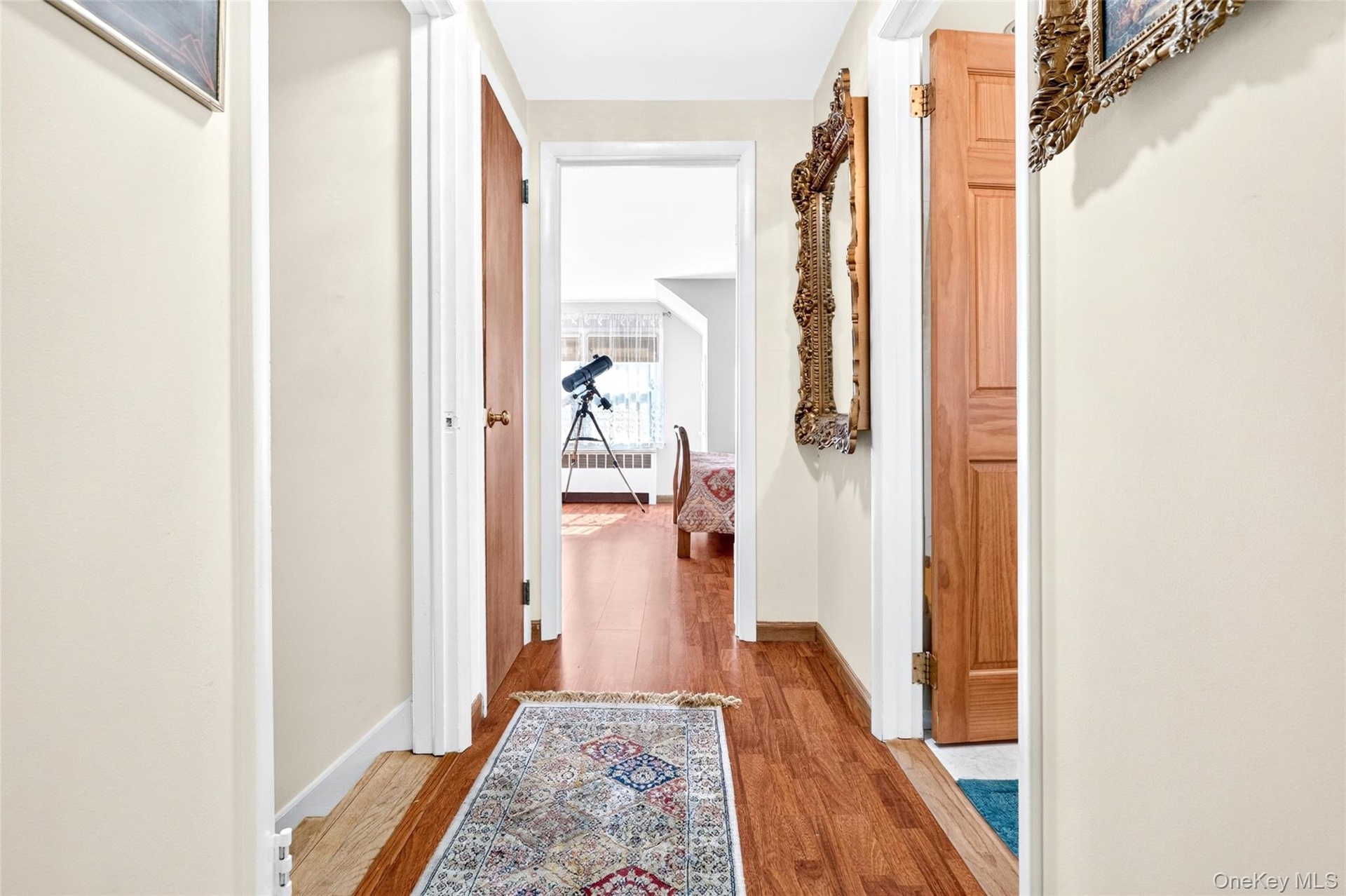 Extra Wide 2nd Floor Hallway, featuring hardwood flooring and entries to the 3rd and 4th Bedrooms and Bathroom.