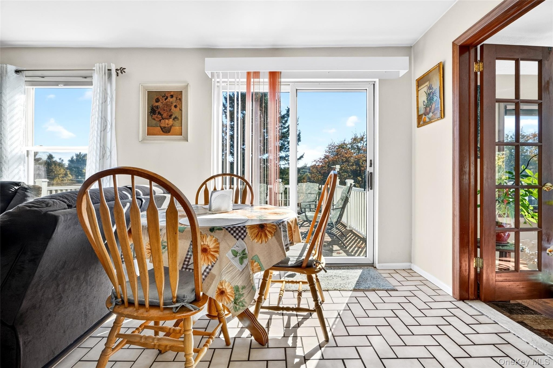 Right off the kitchen, there is a breakfast area and glass sliding doors to the huge deck.