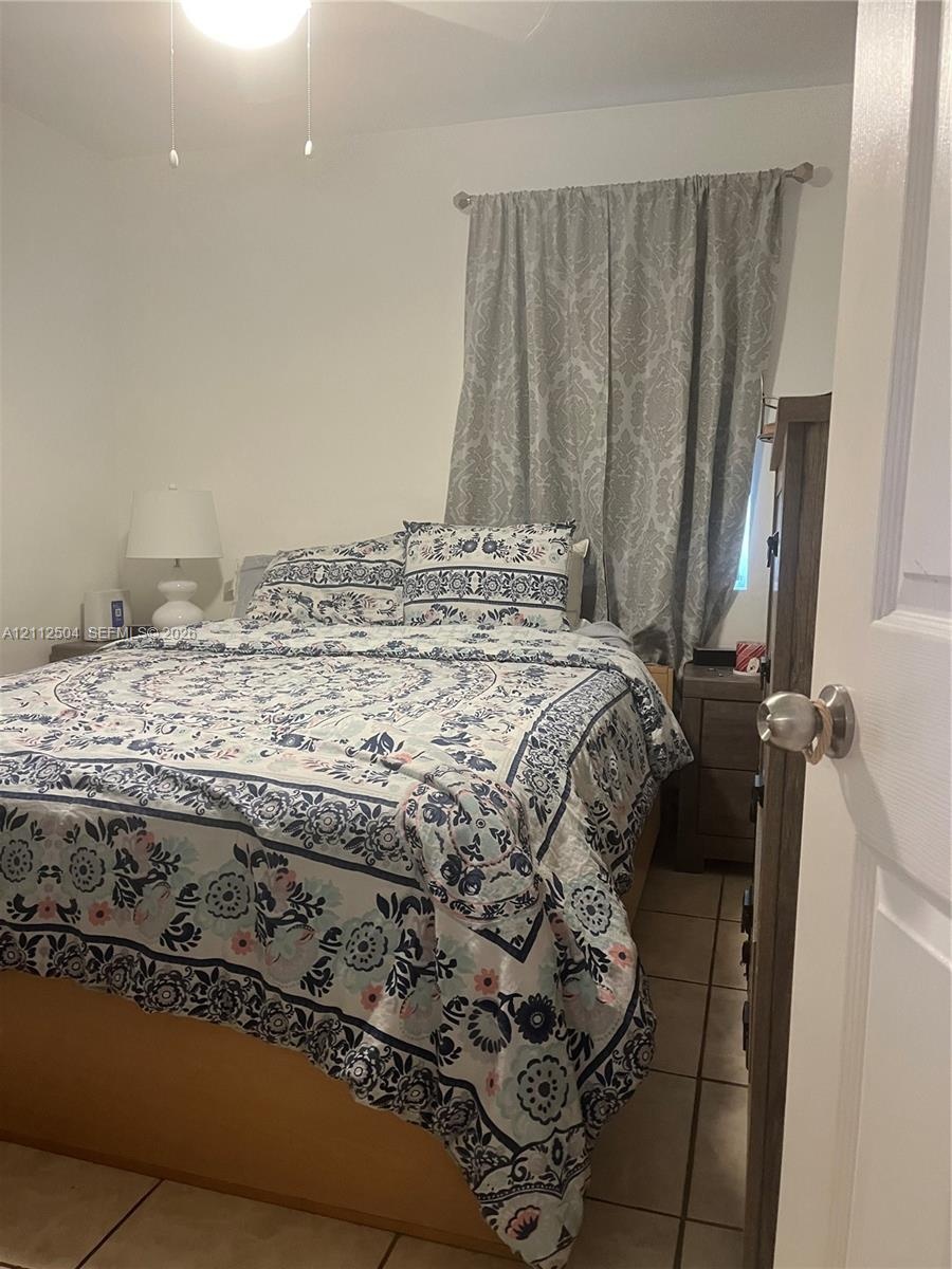 Room featuring neutral wall finishes, tile flooring, and a ceiling-mounted light fixture