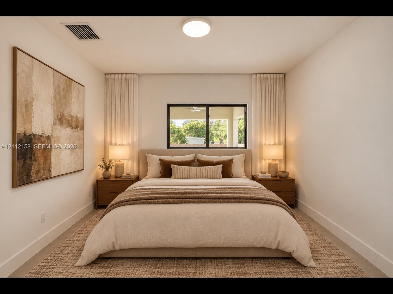 Sleek black-framed window brings in natural light, complemented by recessed lighting and soft neutral tones