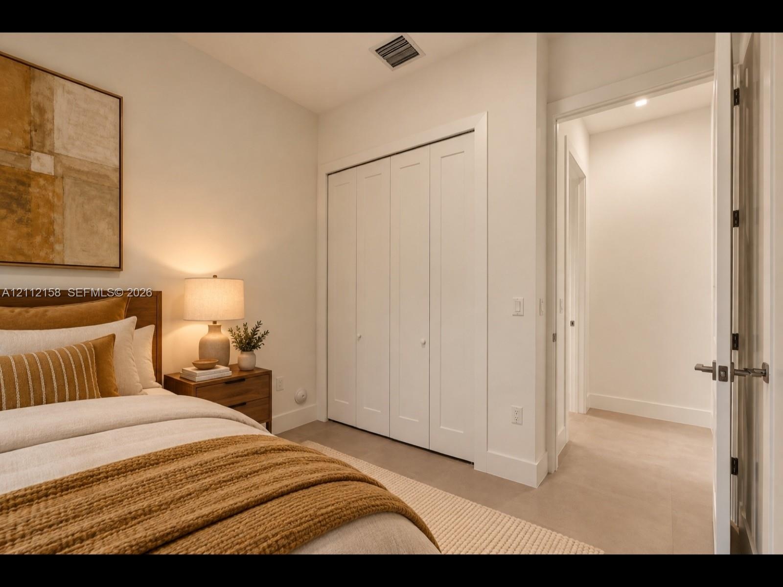 Bright, versatile bedroom with clean finishes, easy-care tile flooring, and a bi-fold closet