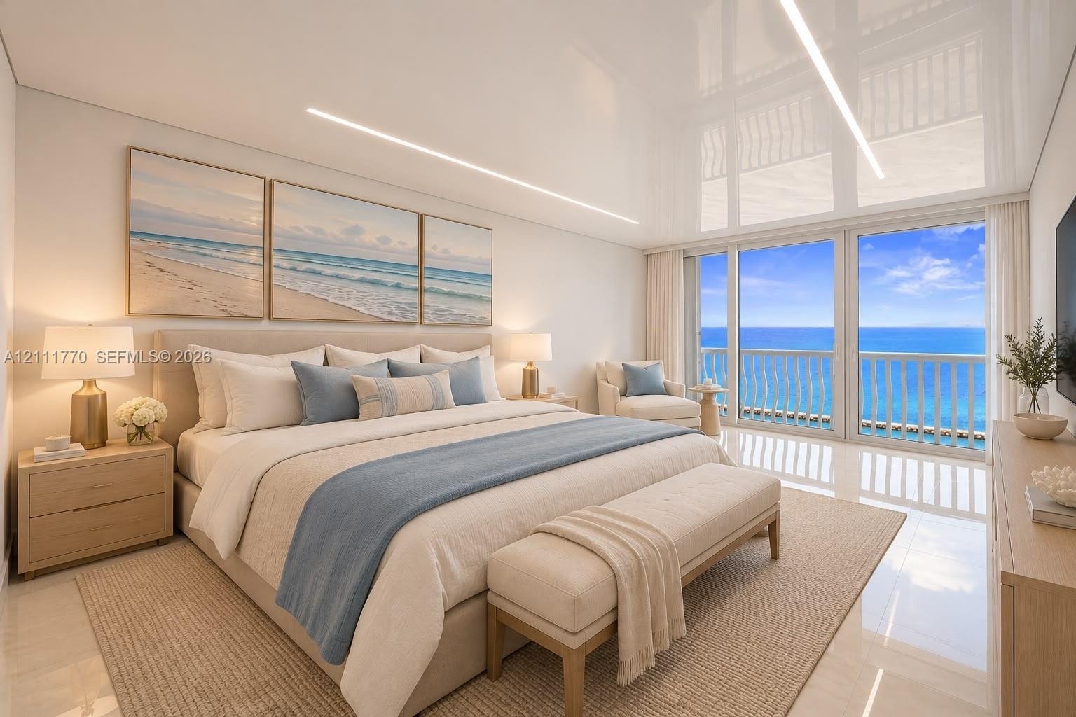 High-gloss ceiling with recessed linear lighting, polished tile flooring, and large-format glass sliding doors opening to a balcony with ocean scenery