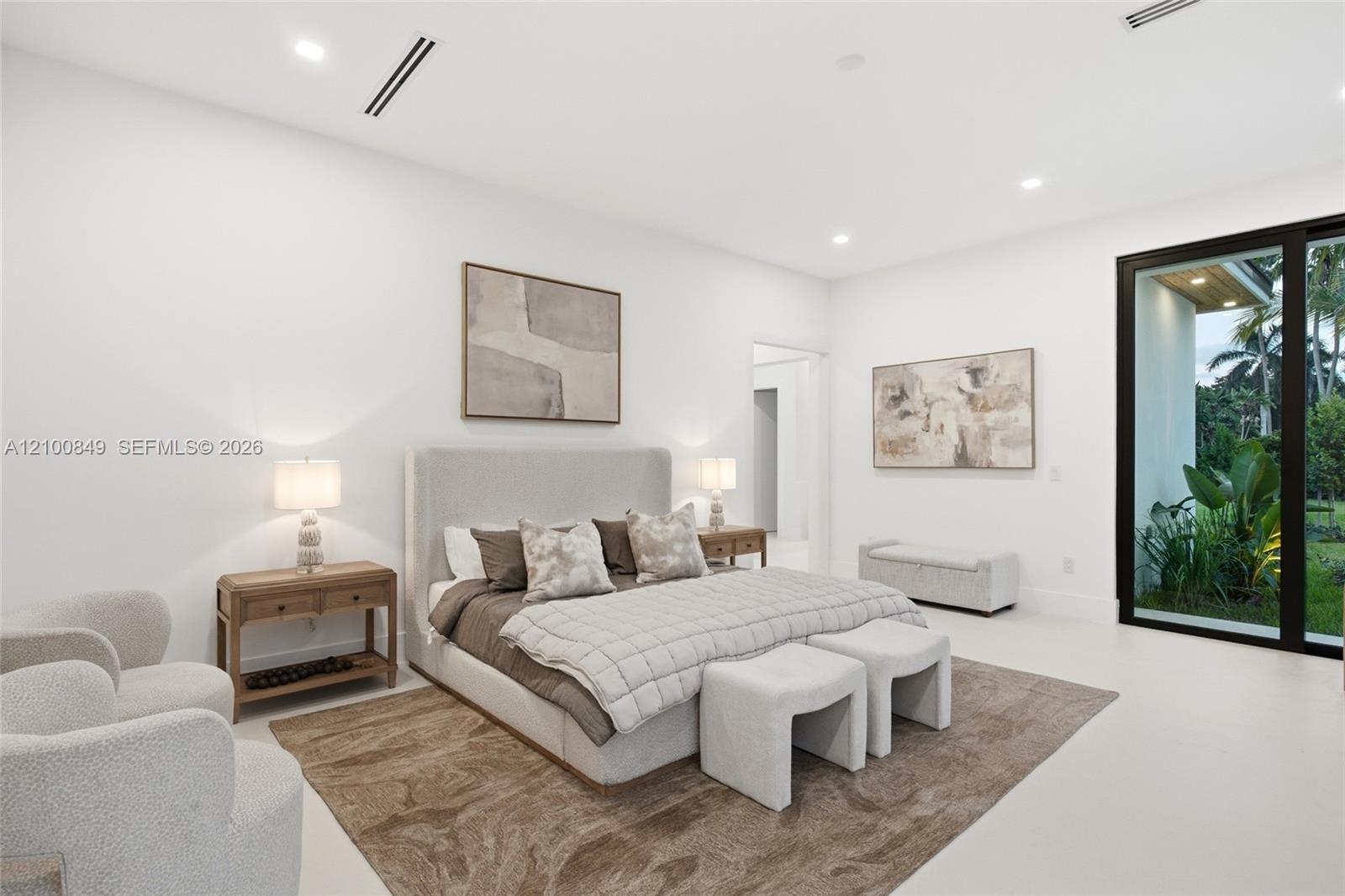 Neutral color palette featuring smooth interior walls, expansive floor-to-ceiling glass panel door, recessed lighting, and continuous polished floorin