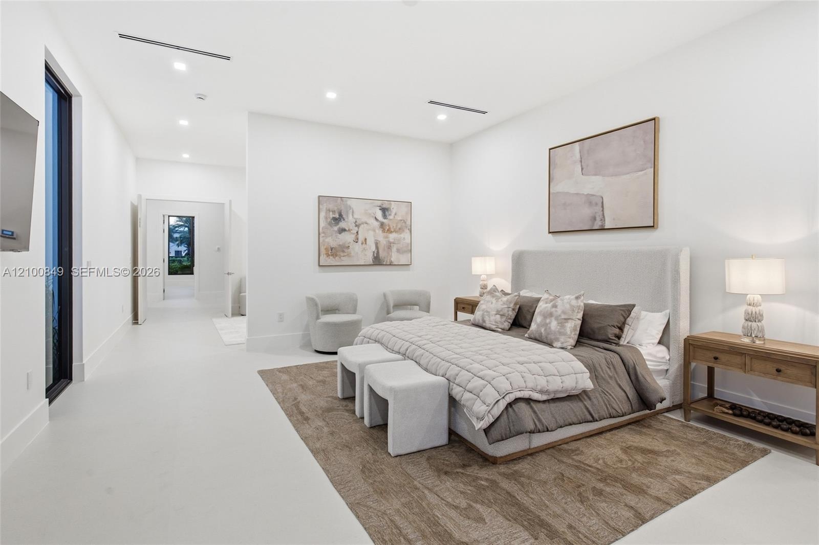 Minimalist interior featuring smooth-finish flooring, recessed linear lighting, and floor-to-ceiling windows