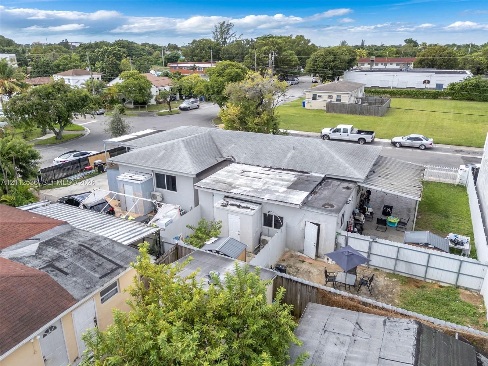 Single-story exterior featuring a hip roof, exterior storage shed, covered outdoor space, and fenced perimeter