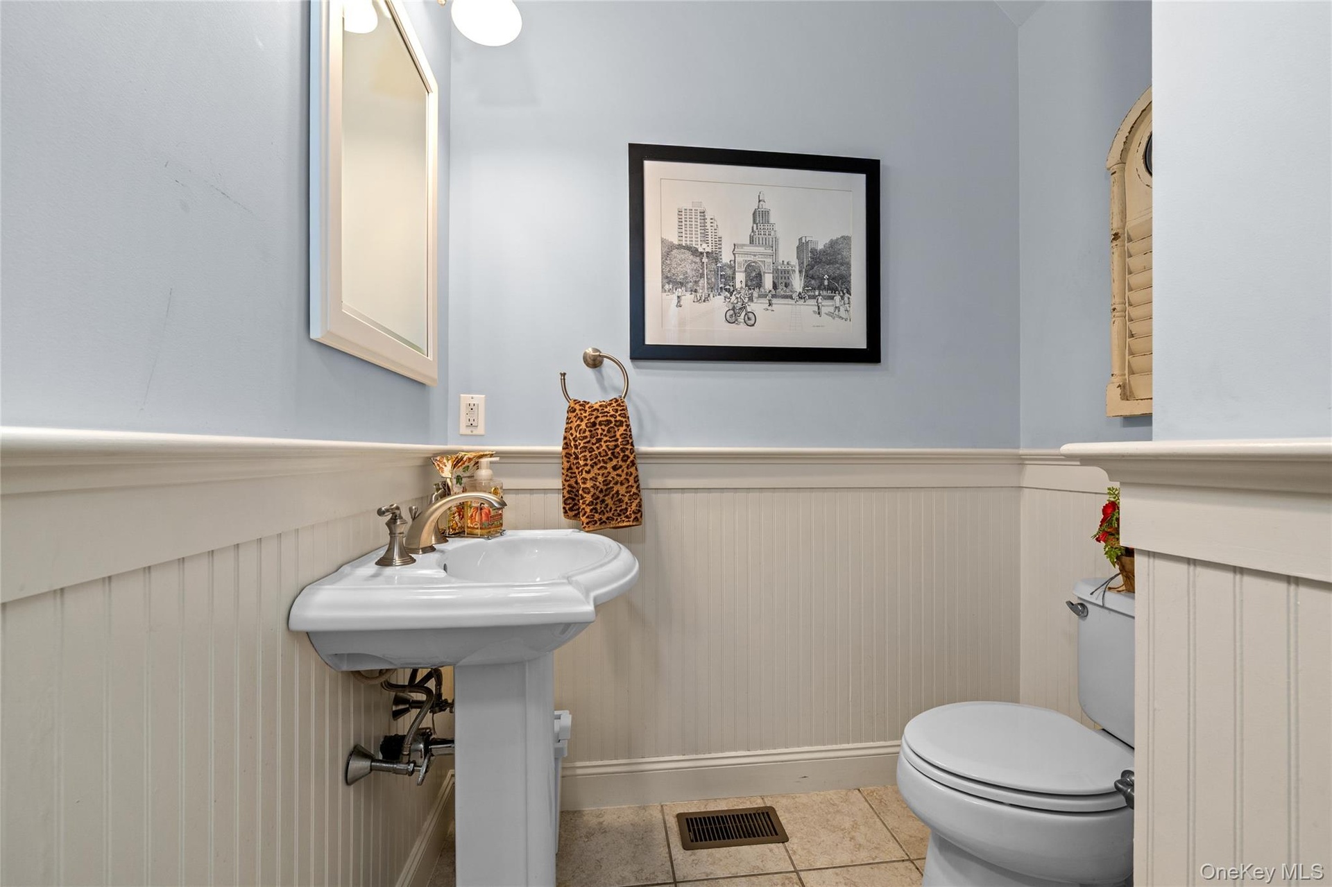The wainscoting and detailing set this half bath apart.