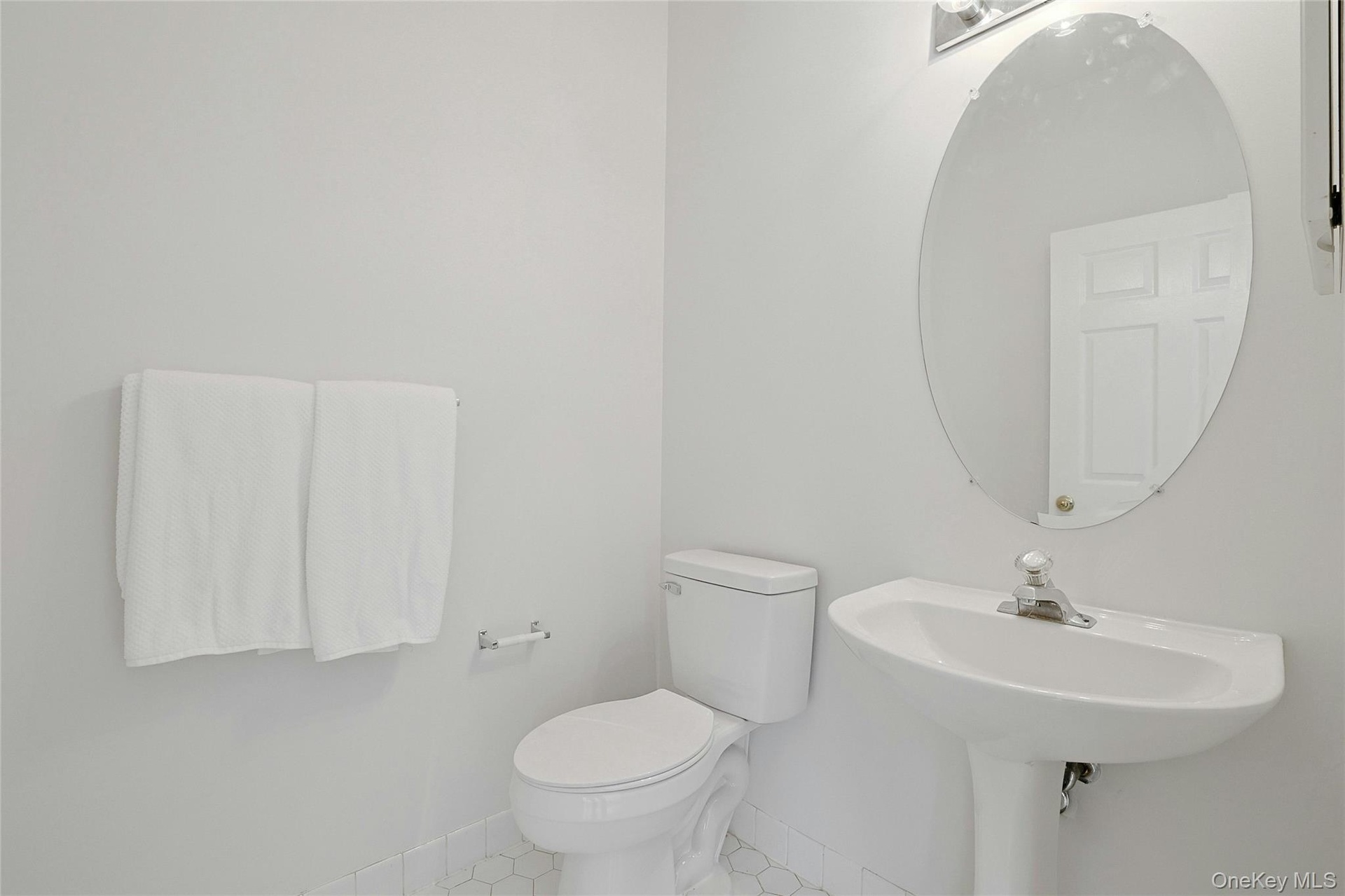 Guest half bath with light fixtures and tiles