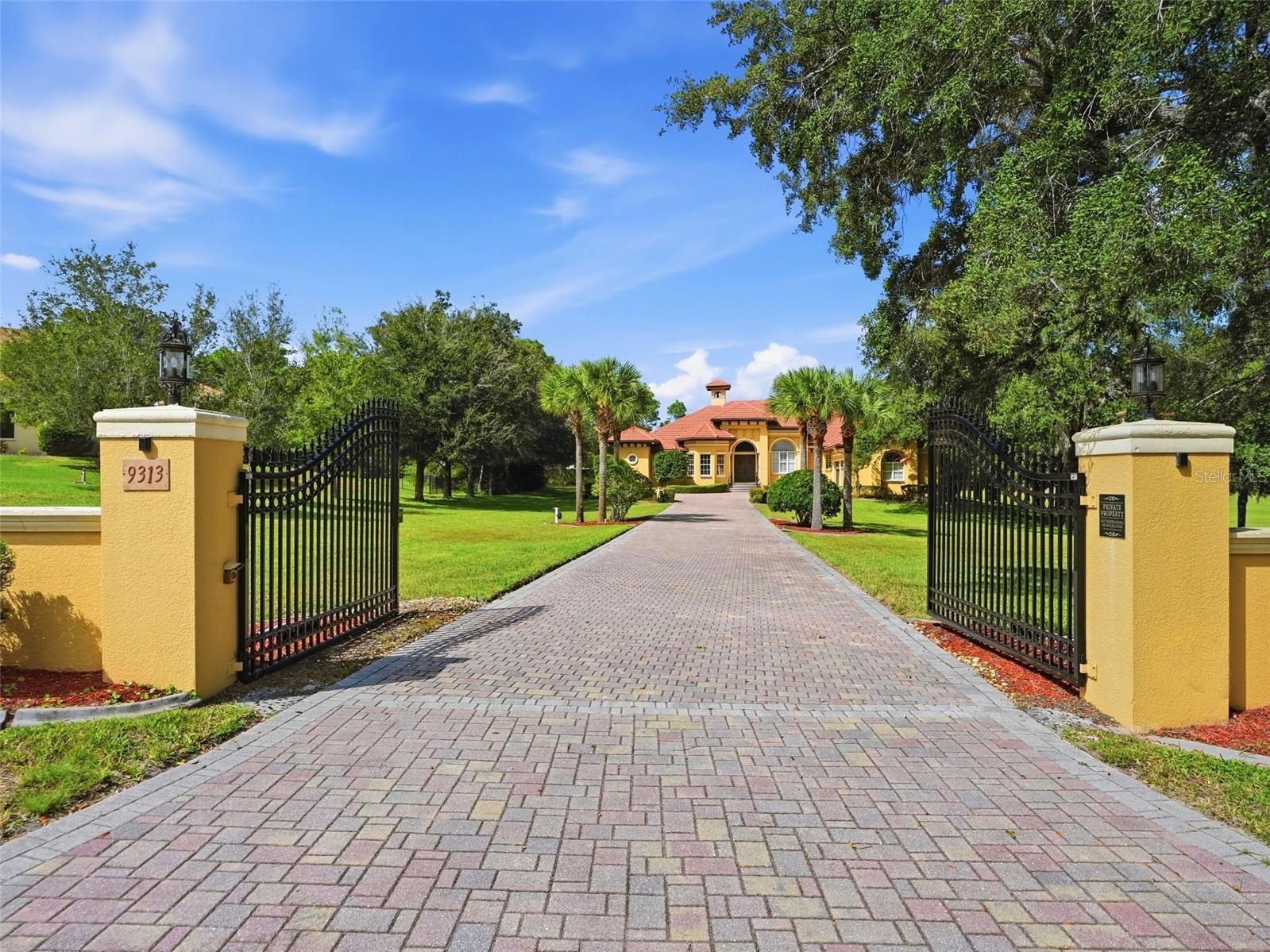 Private gated entrance to the estate with long brick paver driveway! No detail left untouched!