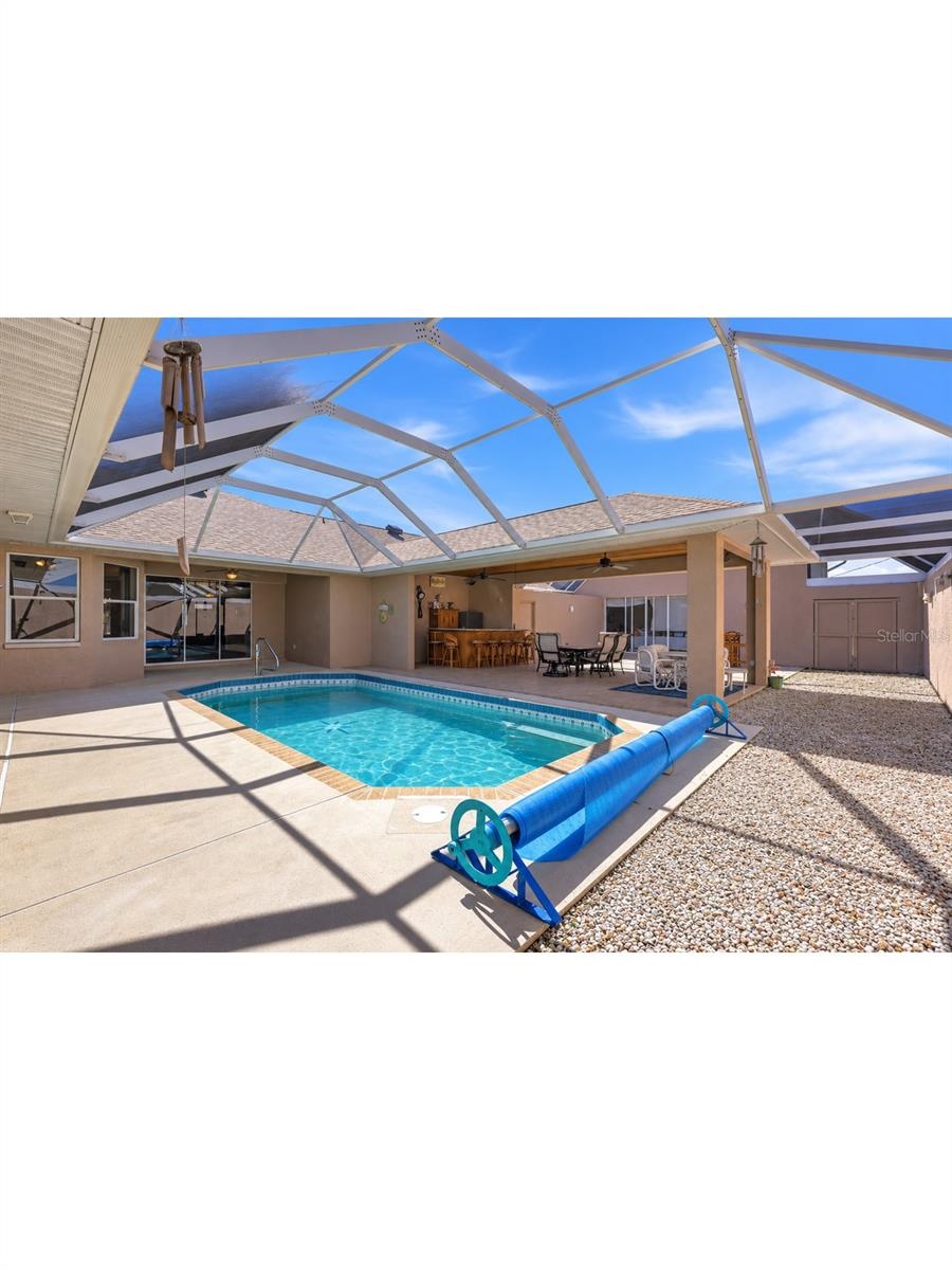 pool deck, bar and entertaining area with sliding doors to house and rv garage