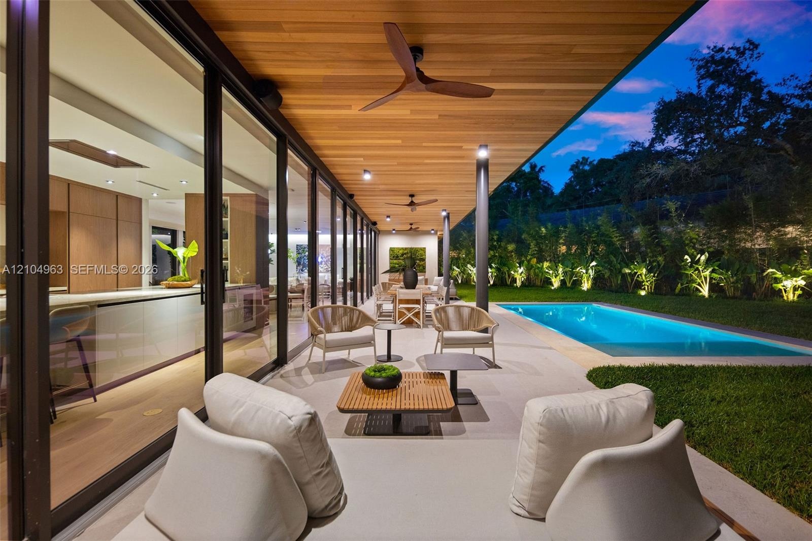 Covered patio featuring a wood-plank ceiling, recessed lighting, ceiling fans, floor-to-ceiling glass sliding doors, and an in-ground swimming pool