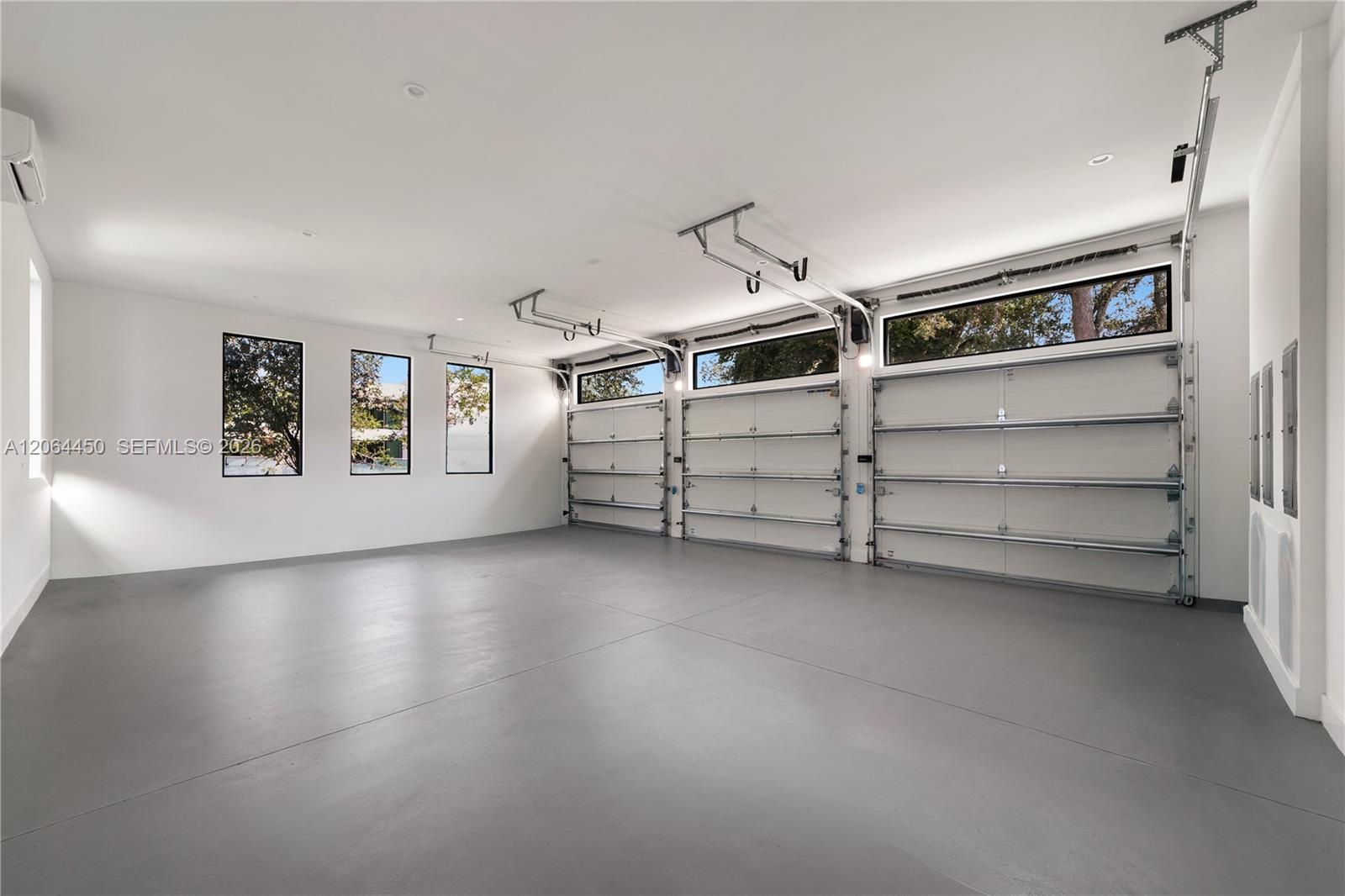 Oversized garage with epoxy floors and ample room for vehicles and storage