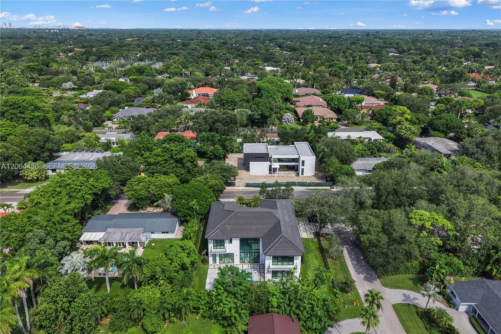 Aerial view of the property set among quiet, tree lined residential streets