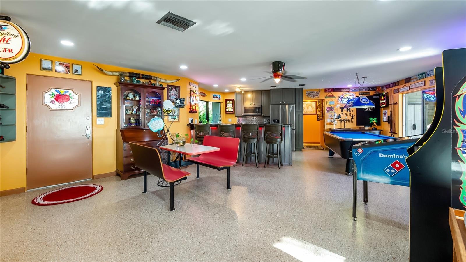 Main Home - Great room/kitchen/living room combo: Living room used as gathering space for game room fun. Two Sliders go out to covered back porch and 
