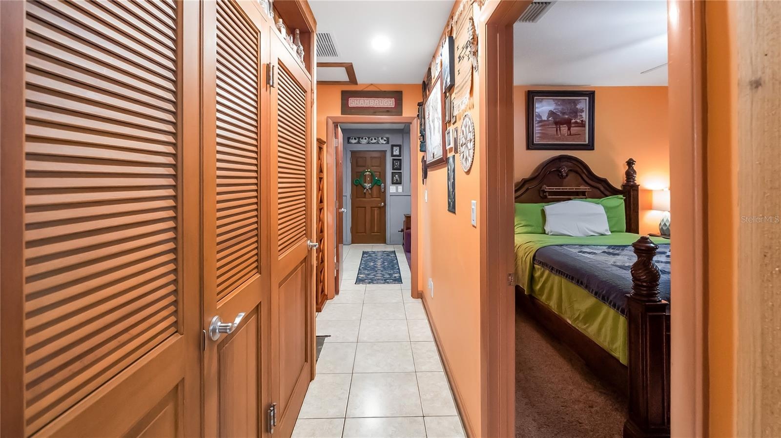 Hall way on guest north side of the main home. Two bedrooms (one being used as TV room, Full bathroom and laundry room. wall of storage closets that l